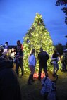 Marines and family members gather around an 18-foot Christmas tree to herald in the holiday season at the Marine Corps Air Station New River Officer’s Club, Dec. 1. 
