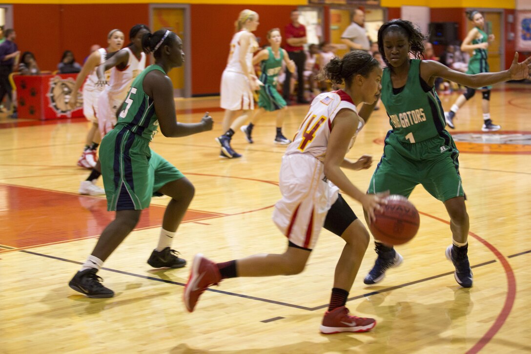 Azaia Wallace, DevilPups’ guard, dribbles the ball across the court during a Lejeune High School girls’ varsity basketball game aboard Marine Corps Base Camp Lejeune, Nov. 26. Wallace and her teammates defeated Spring Creek High School’s Lady Gators with a score of 59-45.