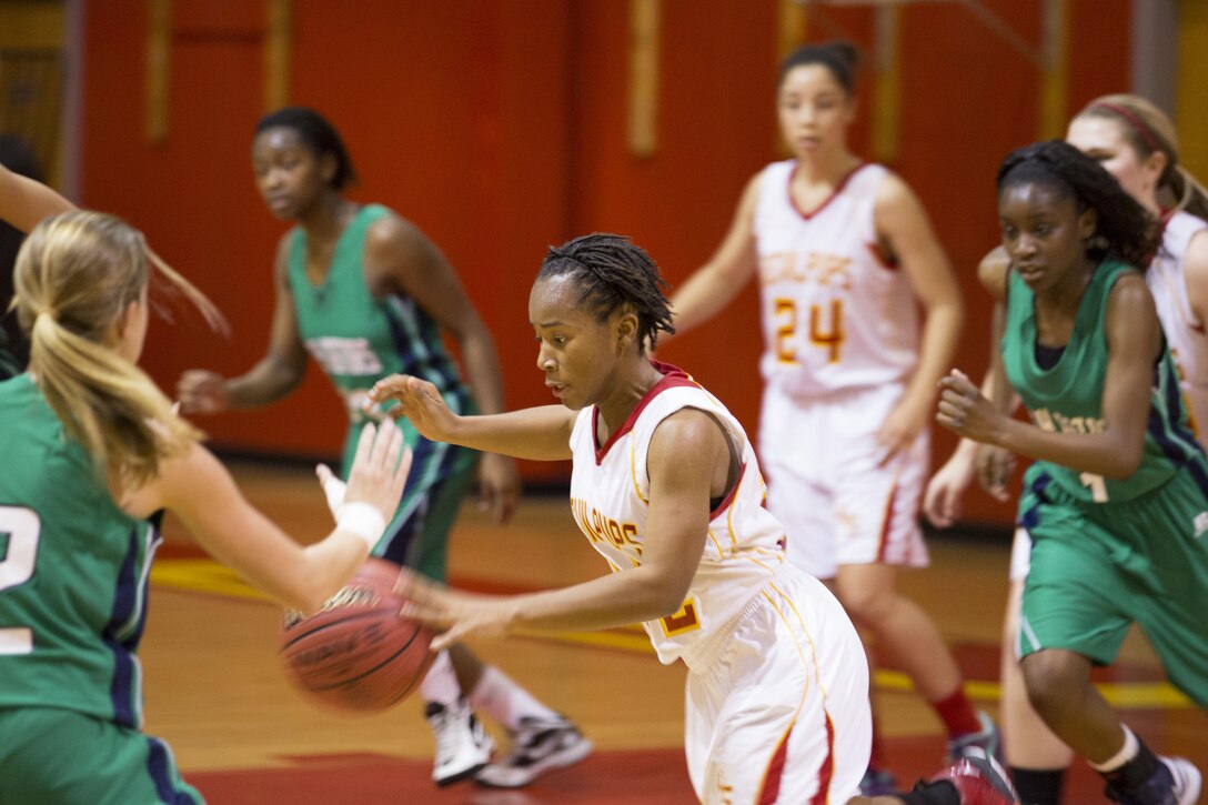 Jarmeela Shaw, Devilpups’ guard, dribbles the ball across the court during a Lejeune High School girls’ varsity basketball game aboard Marine Corps Base Camp Lejeune, Nov. 26. Shaw and her teammates defeated Spring Creek High School’s Lady Gators with a score of 59-45.