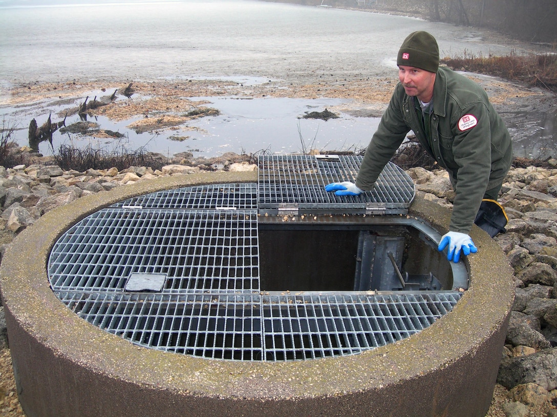Ray Marinan, Natural Resource Specialist in the St. Paul District’s Environmental Section, inspects flow through the French Lake Culvert at Mississippi River Lock & Dam 7 near LaCrosse, Wis. The gated culvert, which is adjusted to a winter setting, was installed in the mid-1990s to provide aerated water from Lake Onalaska to French Lake, located on the downstream side of the dike. French Lake is a popular ice fishing area and the water flow helps maintain good water quality for fish.