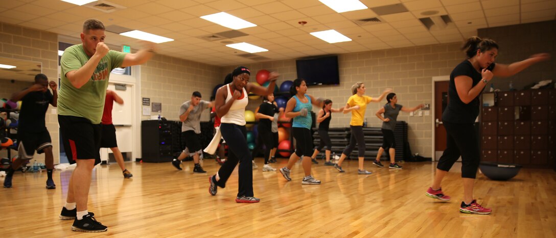 Students at Wallace Creak Fitness Center's Cardio Kickboxing class, including Lee Golden, a environmental protection specialist aboard Marine Corps Base Camp Lejeune,  perform a variety of fast paced kicks and jabs, Dec. 2. The Cardio Kickboxing class takes place Monday's at 11:30 a.m. as well as Tuesday's and Thursday's at 9:30 a.m.