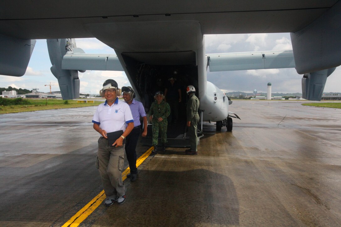 Distinguished guests walk off an MV-22B Osprey after taking a demonstration flight Dec. 4 at Rimba Air Base, Brunei, during the 4th biennial Brunei Darussalam International Defense Exhibition and Conference. Government organizations and various companies at BRIDEX 13 represented approximately 70 countries. The five-day event includes displays and demonstrations of military equipment, with the theme of bridging the capability gap. BRIDEX 13 is an opportunity for communication and cooperation with regional partners and allies, builds strong multilateral relationships and enhances preparedness for disasters and other contingency operations. U.S. participation in BRIDEX 13 demonstrates cooperative engagement with Brunei and continued commitment to regional security and stability in the Asia-Pacific region. The Osprey is assigned to Marine Medium Tiltrotor Squadron 262, Marine Aircraft Group 36, 1st Marine Air Wing, III Marine Expeditionary Force.