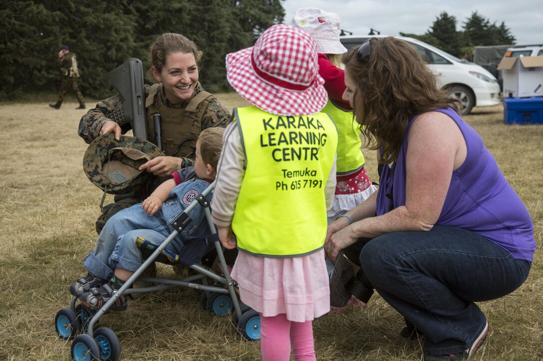 U.S. Marine Corps 2nd Lt. Colleen McFadden, a public affairs officer with I Marine Expeditionary Force, interacts with Karaka Learning Centre preschool students during a guided tour held by the New Zealand Defence Force as part of exercise Southern Katipo 2013 (SK13) at Timaru Airfield, Timaru, New Zealand, Nov. 21, 2013. SK13 is a New Zealand led training exercise that strengthens military relations between coalition forces and helps the New Zealand Defence Force further develop its amphibious capabilities. (U.S. Marine Corps photo by Cpl. Luis A. Vega/ Released) 