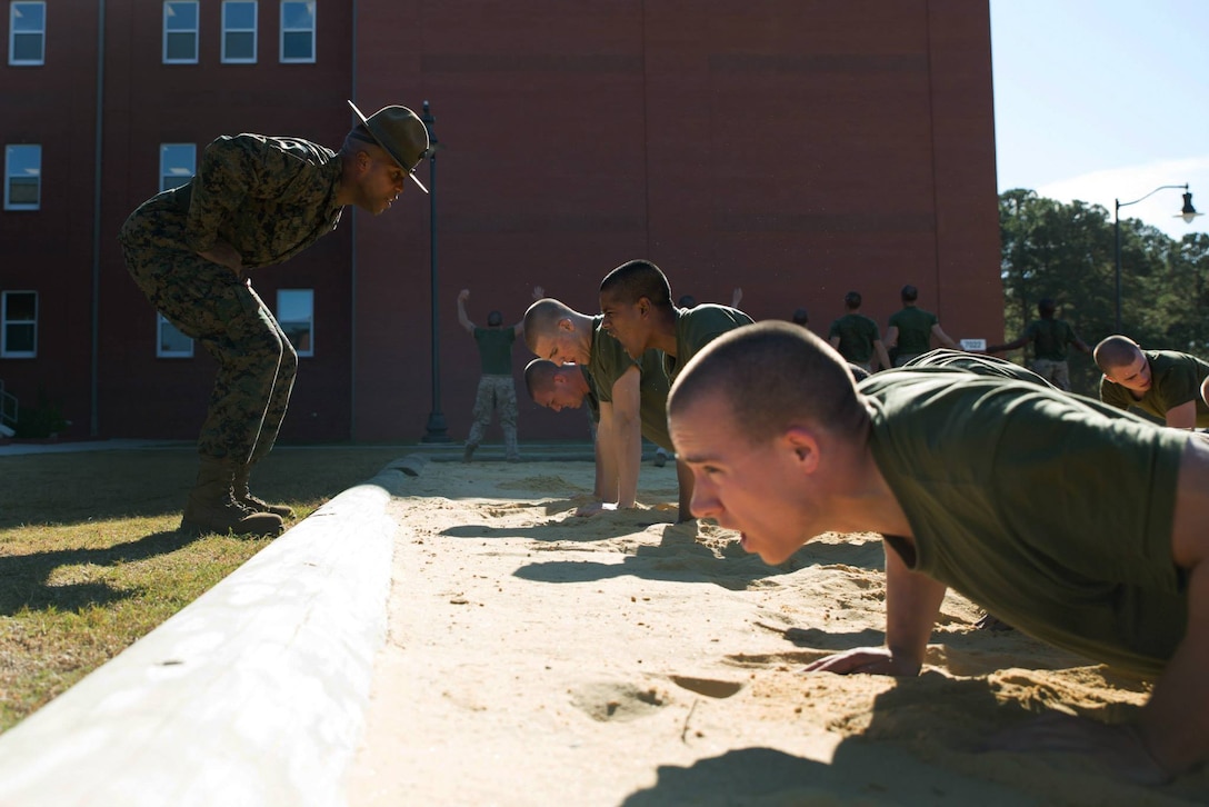Sgt. Kingsley Nwosu, a drill instructor of Platoon 1005, Alpha Company, 1st Recruit Training Battalion, shouts at recruits to do exercises faster during an incentive training session Nov. 14, 2013, on Parris Island, S.C