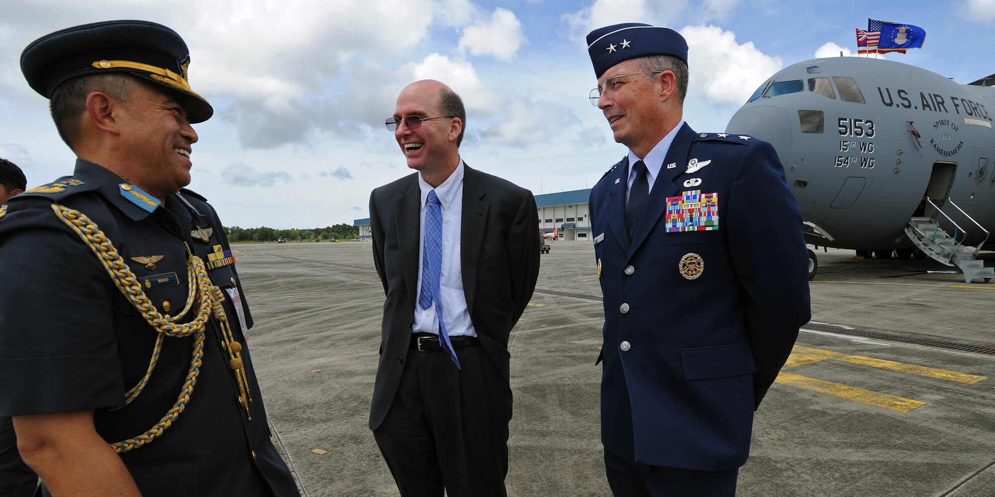 Brig. Gen. (U) Haji Wardi bin Haji Abdul Latip, the commander of the Royal Brunei Air Force, left, U.S. Ambassador to Brunei Daniel L. Shields, center, and Maj. Gen. Paul H. McGillicuddy, Pacific Air Forces chief of staff, right, share a moment as they patiently await the arrival of His Majesty Sultan Haji Hassanal Bolkiahsutan of Brunei at Rimba Air Base during the 4th biennial Brunei Darussalam International Defense Exhibition, Dec. 3, 2013. JBPPH personnel will be showcasing the C-17 Globemaster III through static displays and aerial demonstrations during BRIDEX. The exhibition is an opportunity for networking and sharing technology with regional partners and allies, building strong multilateral relationships, increased cooperation and enhanced preparedness for disasters and other contingency operations. (U.S. Air Force photo/Master Sgt. Jerome S. Tayborn)