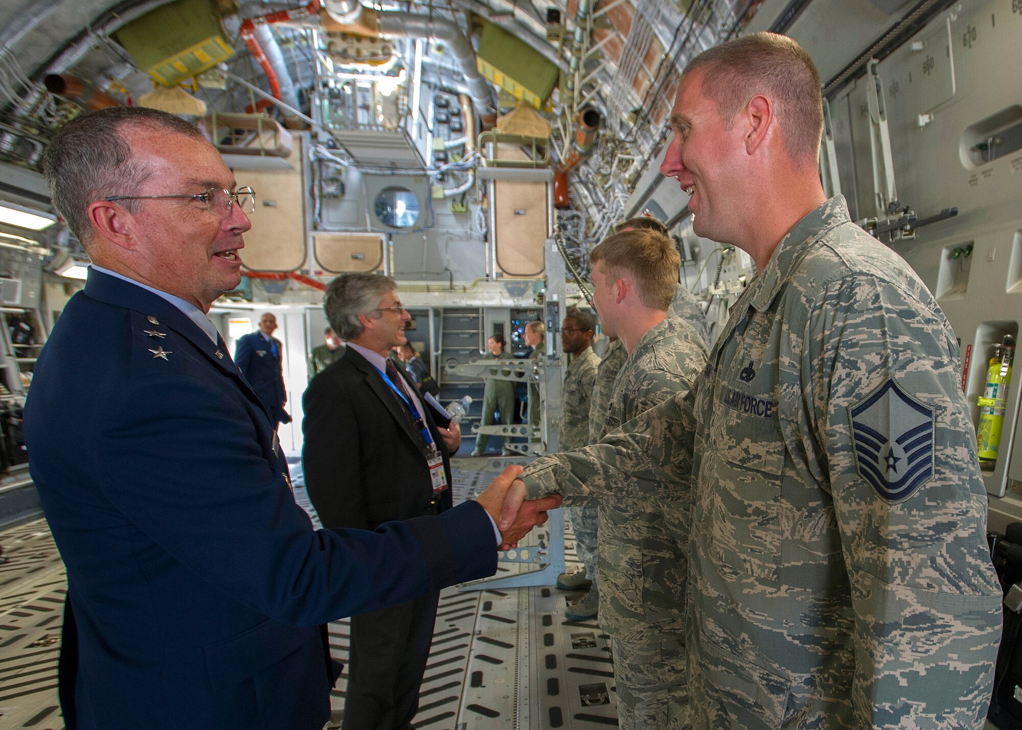 Maj. Gen. Paul H. McGillicuddy, Pacific Air Forces chief of staff, thanks Master Sgt. Matt Smith, 15th Aircraft Maintenance Squadron maintenance lead, for all his team’s hard work during the 4th biennial Brunei Darussalam International Defense Exhibition aboard a C-17 Globemaster III at Rimba Air Base, Dec. 3, 2013. JBPPH personnel will be showcasing the C-17 through static displays and aerial demonstrations during BRIDEX. The exhibition is an opportunity for networking and sharing technology with regional partners and allies, building strong multilateral relationships, increased cooperation and enhanced preparedness for disasters and other contingency operations. (U.S. Air Force photo/Master Sgt. Jerome S. Tayborn)
