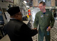 Capt. Rush Taylor, Pacific Air Forces demonstration safety ground control officer, welcomes a local national aboard a C-17 Globemaster III   at Rimba Air Base during the 4th biennial Brunei Darussalam International Defense Exhibition, Dec. 3, 2013. JBPPH personnel will be showcasing the C-17 through static displays and aerial demonstrations during BRIDEX. The exhibition is an opportunity for networking and sharing technology with regional partners and allies, building strong multilateral relationships, increased cooperation and enhanced preparedness for disasters and other contingency operations. (U.S. Air Force photo/Master Sgt. Jerome S. Tayborn)