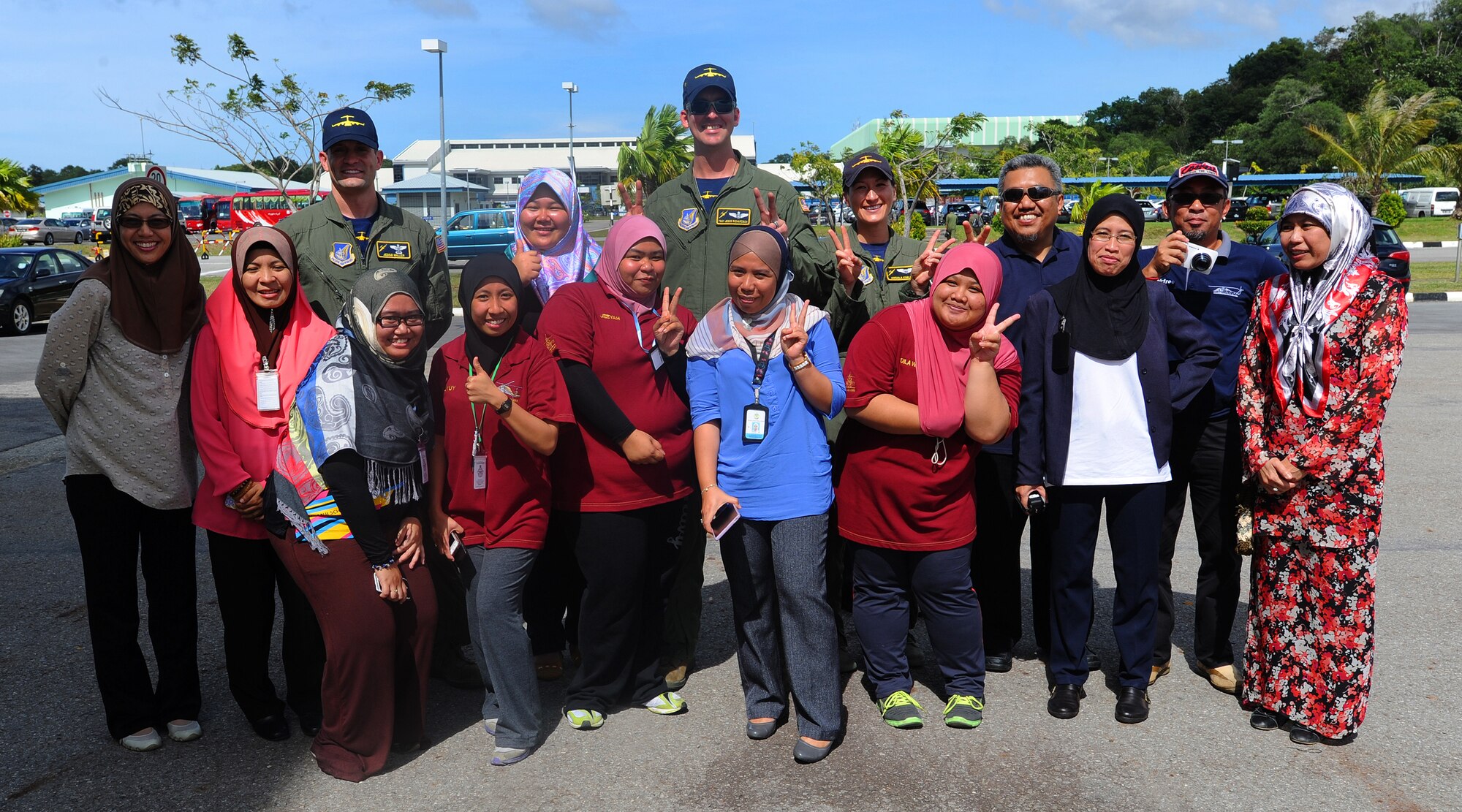 Members of the Pacific Air Forces demonstration team pose for a group photo with local nationals at Rimba Air Base during the 4th biennial Brunei Darussalam International Defense Exhibition, Dec. 3, 2013.  JBPPH personnel will be showcasing the C-17 Globemaster III through static displays and aerial demonstrations during BRIDEX. The exhibition is an opportunity for networking and sharing technology with regional partners and allies, building strong multilateral relationships, increased cooperation and enhanced preparedness for disasters and other contingency operations. (U.S. Air Force photo/Master Sgt. Jerome S. Tayborn)