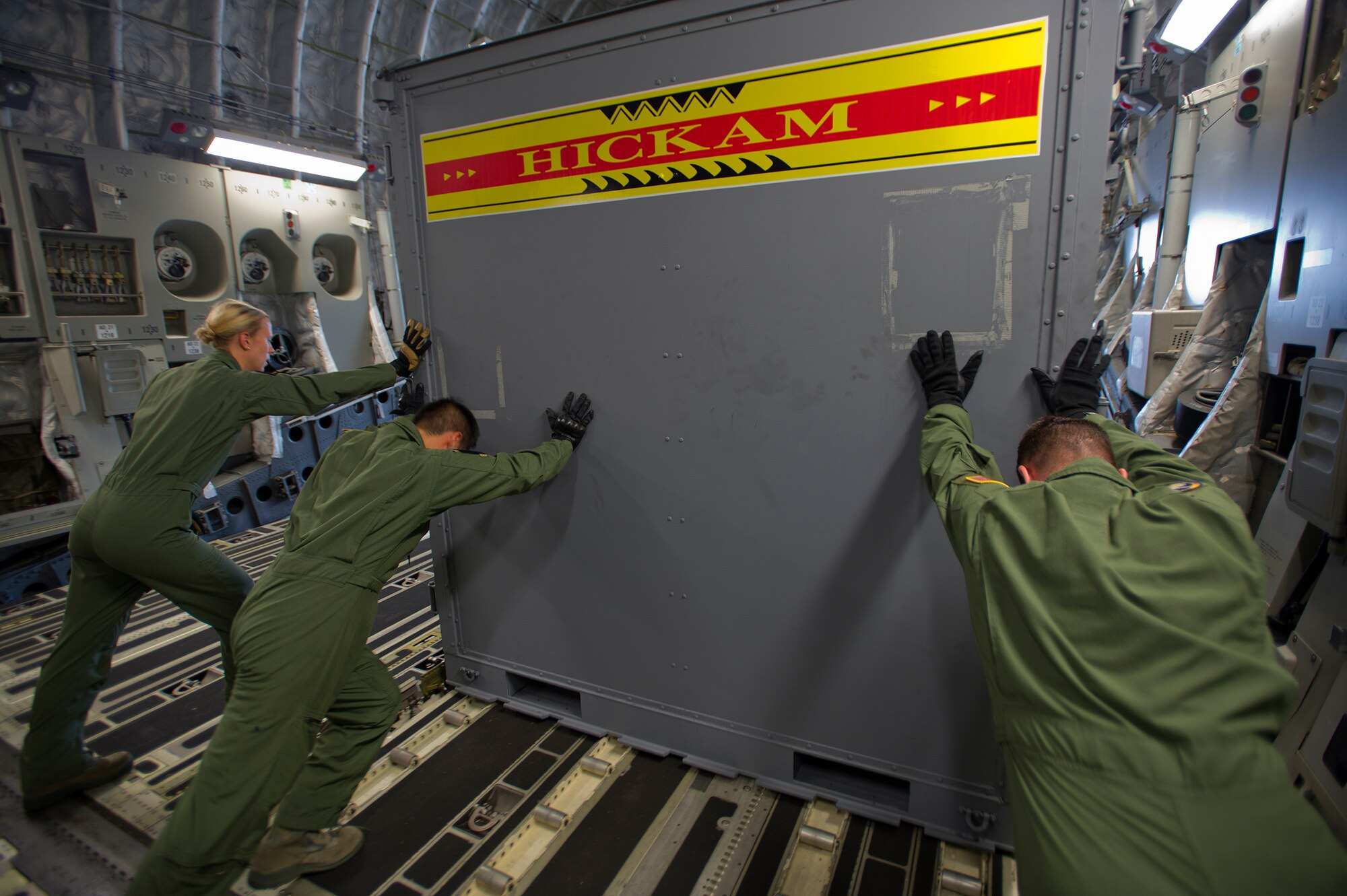 Joint Base Pearl Harbor-Hickam Airmen from the 535th Airlift Squadron unload a container from a C-17 Globemaster III at Rimba Air Base in preparation for the 4th Biennial Brunei Darussalam International Defense Exhibition, Dec. 1, 2013. JBPPH personnel will be showcasing the C-17 through static displays and aerial demonstrations during BRIDEX. The exhibition is an opportunity for networking and sharing technology with regional partners and allies, building strong multilateral relationships, increased cooperation and enhanced preparedness for disasters and other contingency operations. (U.S. Air Force photo/Master Sgt. Jerome S. Tayborn)