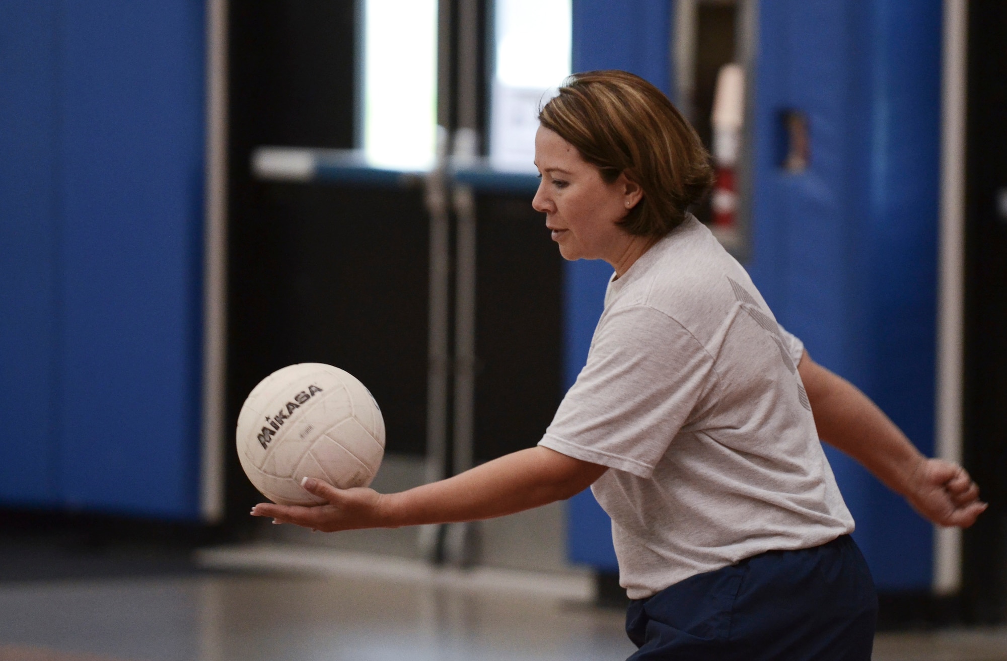 Rena Banes, 36th Maintenance Group first sergeant, serves the ball during a volleyball game Dec. 2, 2013, at the Coral Reef Fitness Center on Andersen Air Force Base, Guam. The “ALS versus Shirts” volleyball game between Airman Leadership School students and first sergeants is an Air Force-wide tradition. The 36th Wing first sergeants defeated the ALS students, 3-1 sets. (U.S. Air Force photo by Senior Airman Marianique Santos/Released)