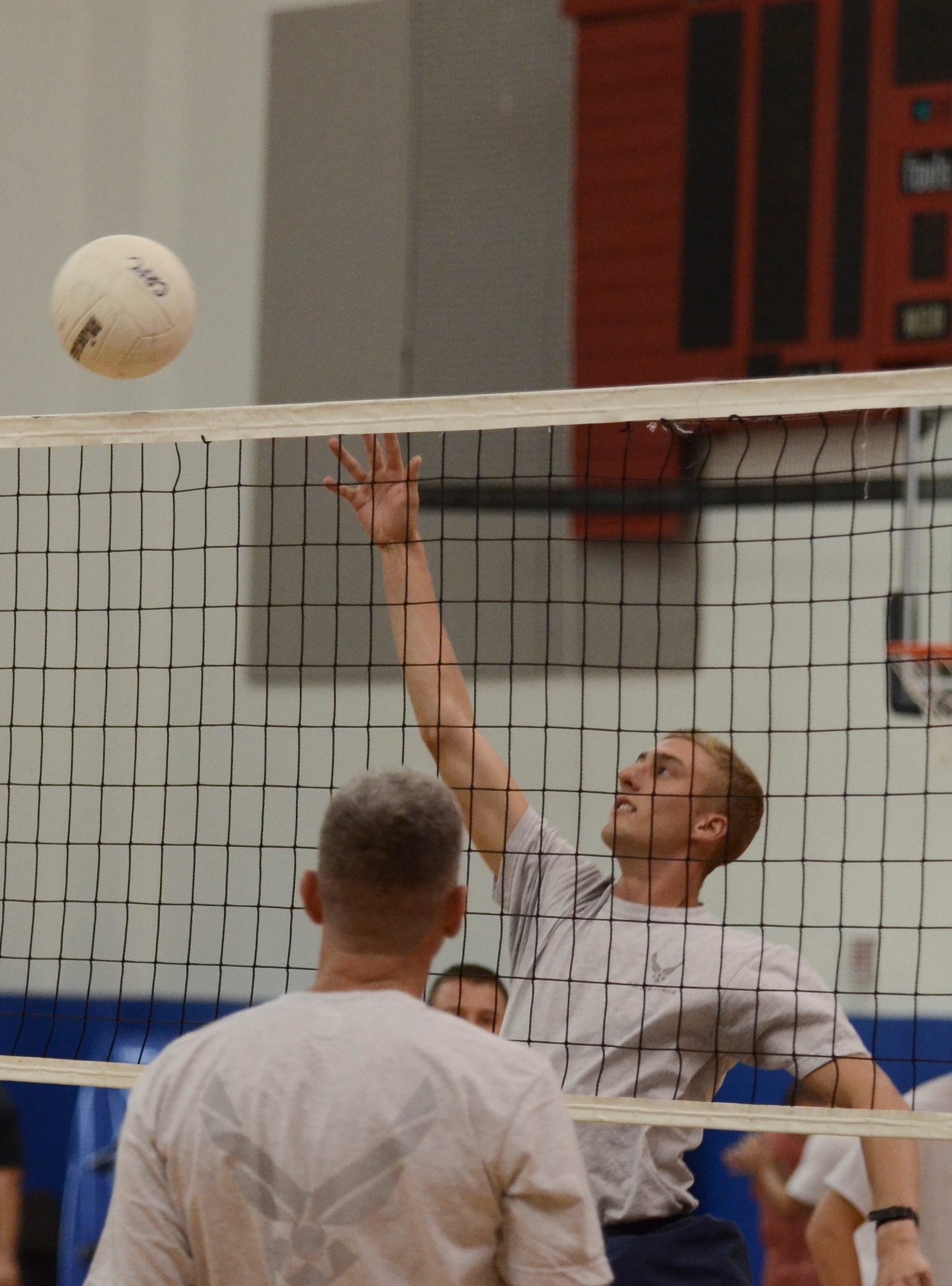 Jacob Johnson, current Airman Leadership School student from the 36th Munitions Squadron, hits the volleyball over the net during a game Dec. 2, 2013, at the Coral Reef Fitness Center on Andersen Air Force Base, Guam. The “ALS versus Shirts” volleyball game between the students and first sergeants is an Air Force-wide tradition. The 36th Wing first sergeants defeated the ALS students, 3-1 sets. (U.S. Air Force photo by Senior Airman Marianique Santos/Released)