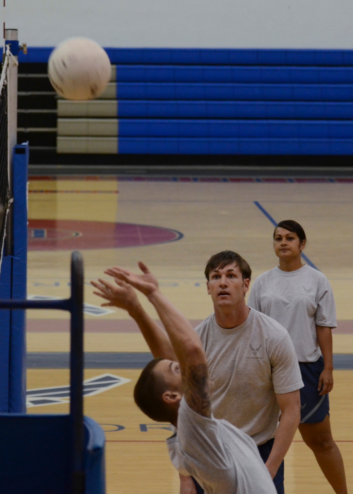 Adam Lloyd, current Airman Leadership School student from the 36th Medical Operations Squadron, sets the volleyball over the net during a game Dec. 2, 2013, at the Coral Reef Fitness Center on Andersen Air Force Base, Guam. The “ALS versus Shirts” volleyball game between the students and first sergeants is an Air Force-wide tradition. The 36th Wing first sergeants defeated the ALS students, 3-1 sets. (U.S. Air Force photo by Senior Airman Marianique Santos/Released)