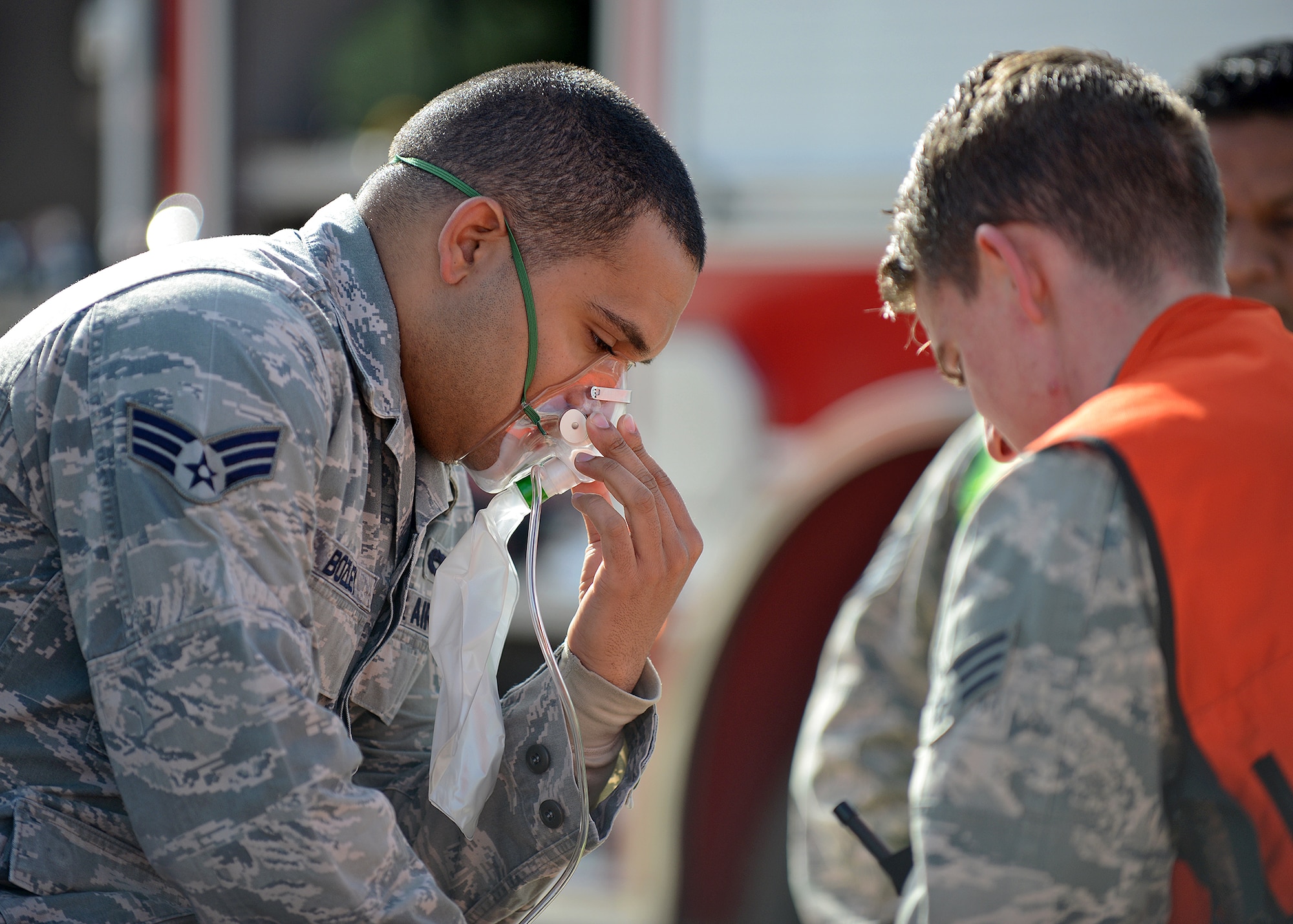 Senior Airman James Bozley, 412th Maintenance Group F-16 squadron lead crew member, simulates being treated by 412th Medical Group emergency response personnel during a base emergency scenario exercise that occurred Nov. 26 in Hangar 1210. The purpose of the exercise was so Exercise Evaluation Team members could assess how on-base emergency response personnel gain and maintain control of a site after a fire suppression system discharge incident has occurred. (U.S. Air Force photo by Jet Fabara)