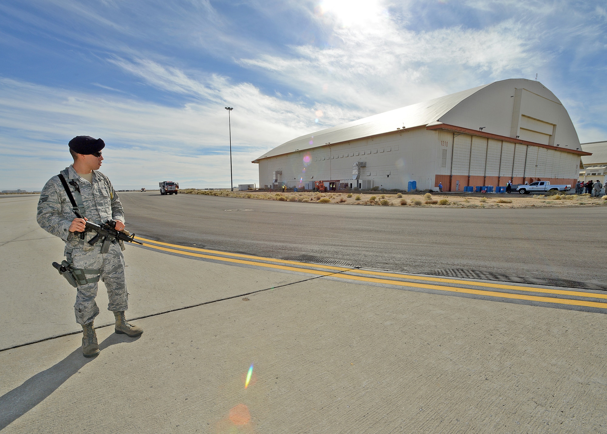 Senior Airman Matthew Skinner, 412th Security Forces Squadron specialist, helps establish a cordon Nov. 26 during an emergency scenario exercise. During this exercise, the Exercise Evaluation Team tried to get several people to sneak or bluff their way past control zones and reenter the facility. (U.S. Air Force photo by Jet Fabara)