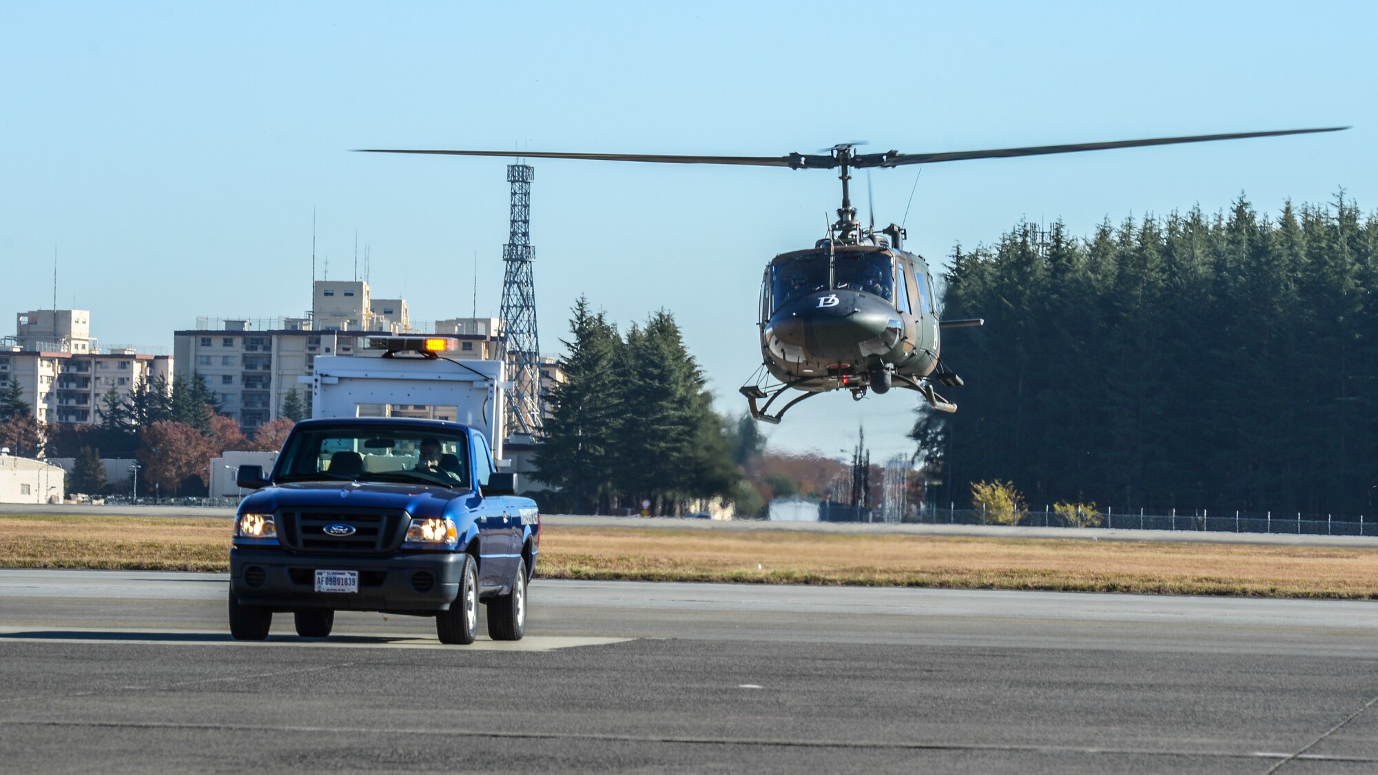 A Japanese UH-1 Huey prepares for landing during the Tokyo Metropolitan Government disaster relief exercise at Yokota Air Base, Japan, Nov. 23, 2013.  Both Japanese and American aircraft delivered relief supplies to Yokota and transported them to corresponding destination to support the simulated disaster.  (U.S. Air Force photo by Airman 1st Class Soo C. Kim / Released)