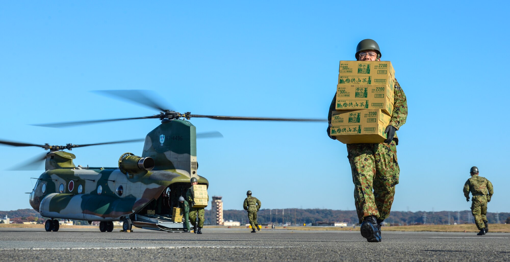 A Japan Ground Self-Defense Forces member carries disaster relief supplies from a Japanese CH-47 Chinook during the Tokyo Metropolitan Government disaster relief exercise at Yokota Air Base, Japan, Nov. 23, 2013.  The exercise was an opportunity for both Japanese and American forces to work together, enhancing and preparing for possible future disasters.  (U.S. Air Force photo by Airman 1st Class Soo C. Kim / Released)