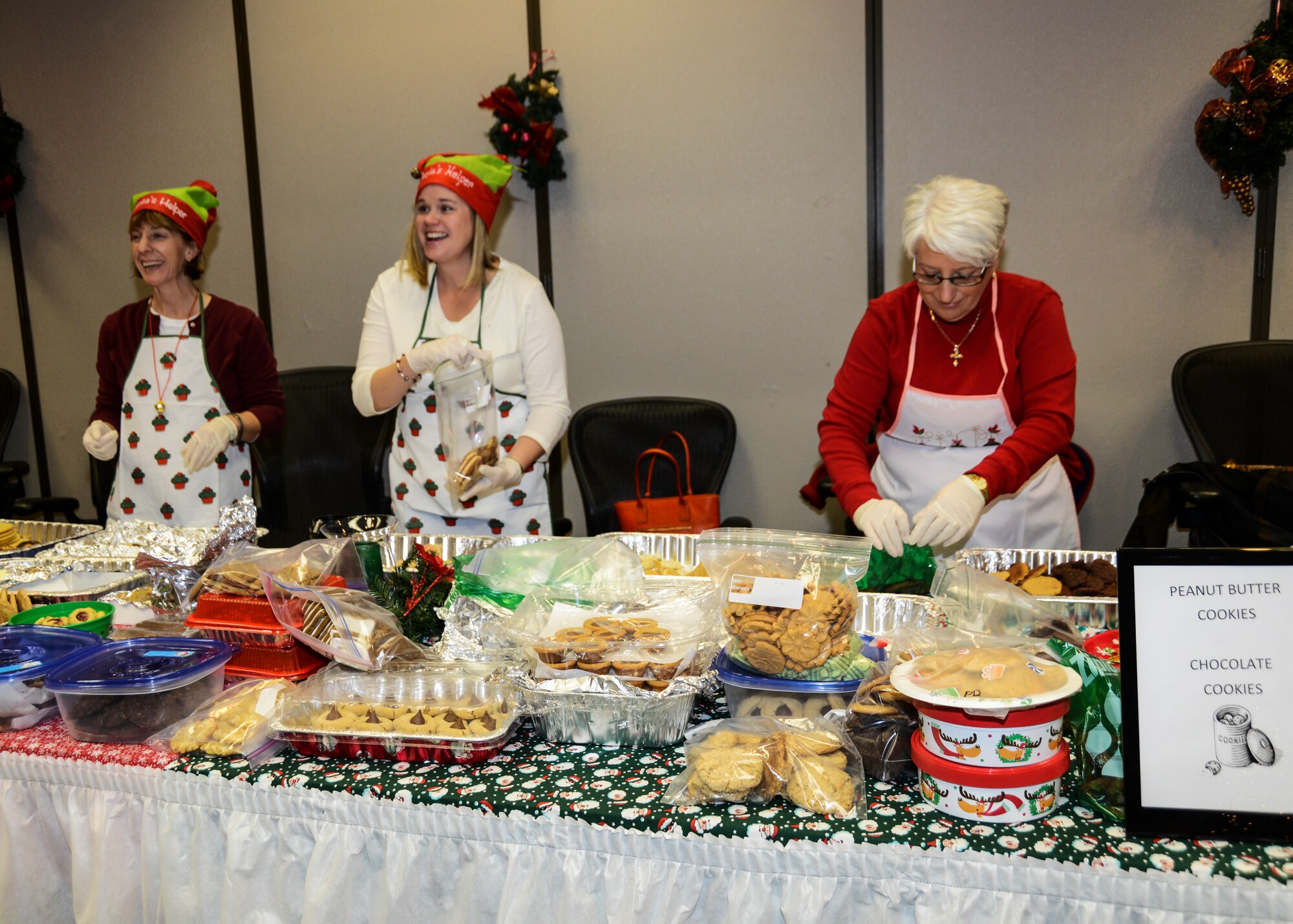 (From left to right) Susan Weaver, 412th Mission Support Group, Jennifer Henderson, 412th Air Force Test Center and Sue Kovras, 412th Force Support Squadron, sort through cookie donations for the annual Cookie Drop at the Airman and Family Readiness Center Dec. 4. The cookies were later picked up by unit first sergeants and delivered to single Airmen all over Edwards. (U.S. Air Force photo by Rebecca Amber)