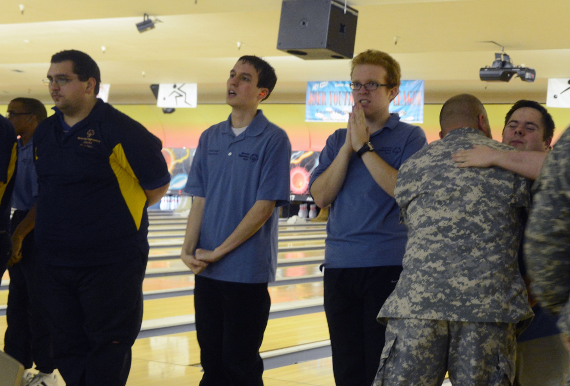 JOINT BASE ELMENDORF-RICHARDSON, Alaska -- A Soldier from Joint Base Elmendorf-Richardson presents awards to Special Olympics athletes during the Special Olympics Bowling Tournament at the Joint Base Elmendorf-Richardson Polar Bowl Nov. 23. Participants came from different portions of Alaska to qualify for more competitions. (U.S. Air Force photo/Airman 1st Class Ty-Rico Lea)