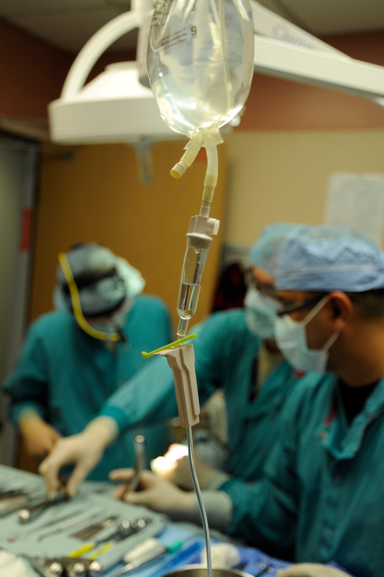 A saline solution is administered to a patient during an oral surgery Dec. 2, 2013, at Nellis Air Force Base, Nev. The liquid is designed to help the body function as needed following trauma and surgeries as well as keeping patients hydrated. (U.S. Air Force photo by Airman 1st Class Timothy Young)