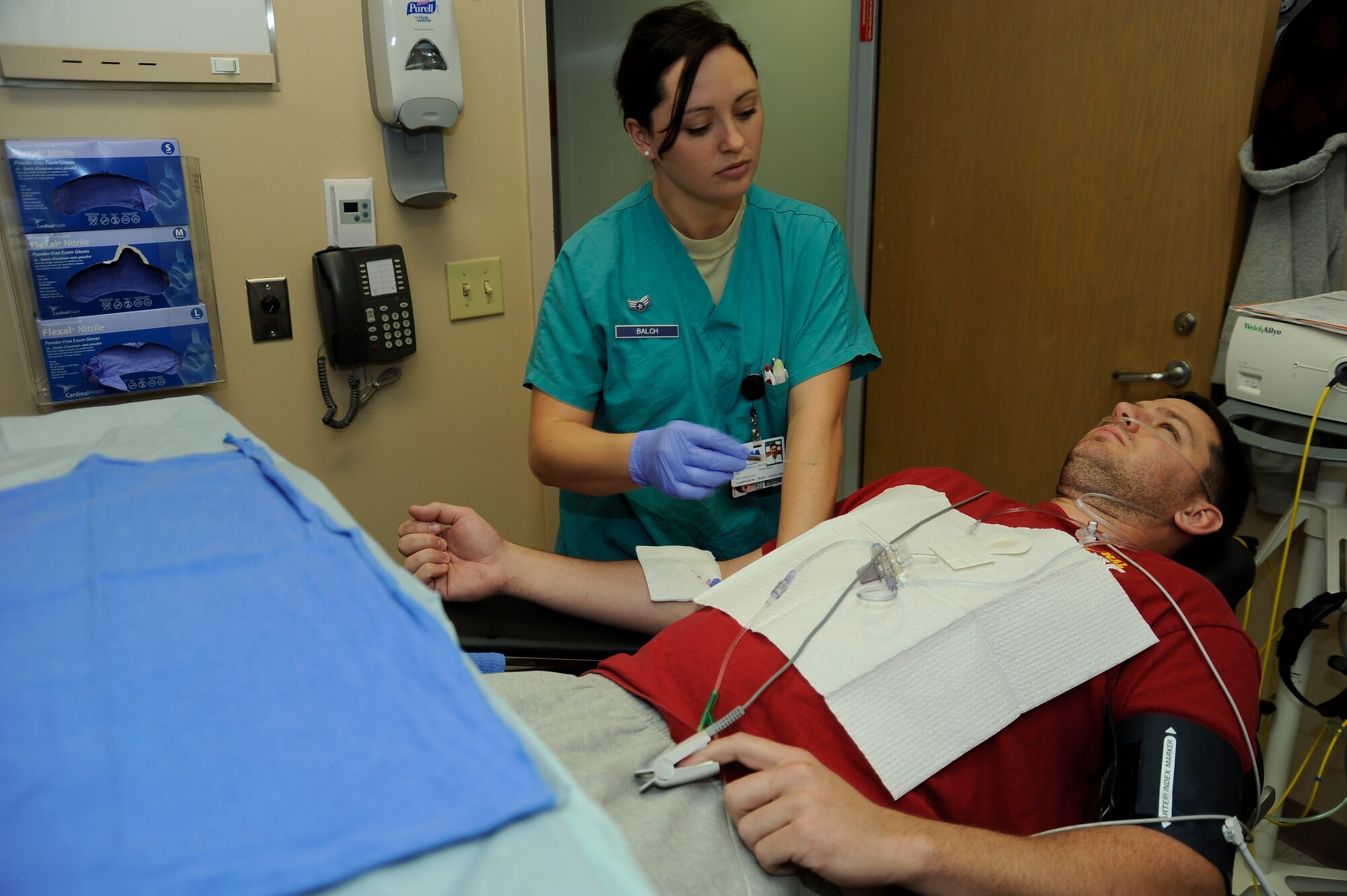 Senior Airman Kelly Balch, 99th Dental Squadron dental assistant, places an IV into the arm of Senior Airman Bradley Jacob, 99th Civil Engineer Squadron power production journeyman, before an oral surgery Dec. 2, 2013, at Nellis Air Force Base, Nev.  Jacob’s surgery involved the removal of both top molars. (U.S. Air Force photo by Airman 1st Class Timothy Young)