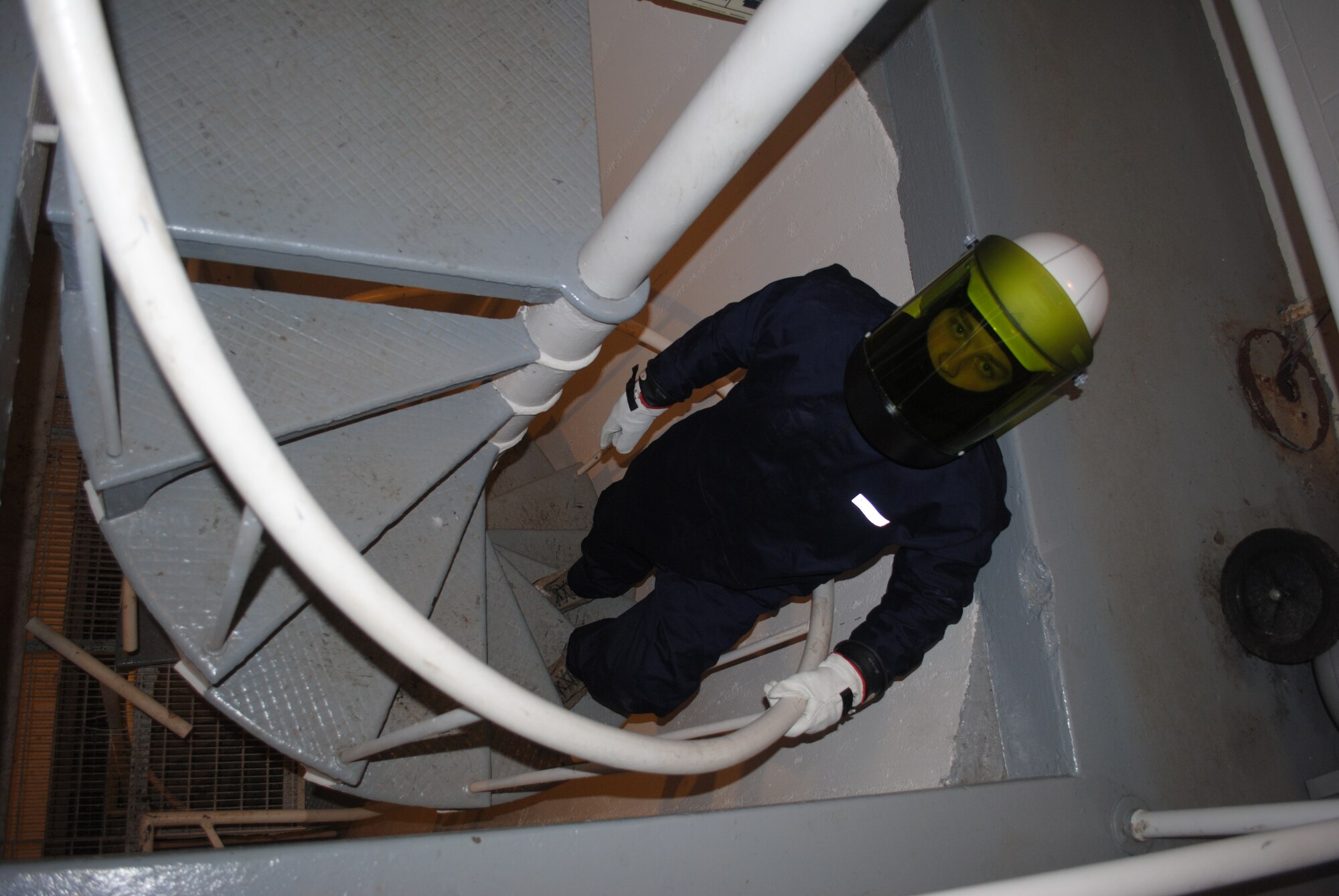 Airman 1st Class Zachary Jacobs, 319th Civil Engineer Squadron electrical power production technician, walks up a spiral staircase after checking the operational status of electrical generators Grand Forks Air Force Base, N.D., Dec. 4, 2013. The 319th CES checks all generators on a routine basis in order to ensure the base has sufficient electrical power to maintain essential operations during severe winter weather. (U.S. Air Force photo/Staff Sgt. Luis Loza Gutierrez) 
