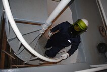 Airman 1st Class Zachary Jacobs, 319th Civil Engineer Squadron electrical power production technician, walks up a spiral staircase after checking the operational status of electrical generators Grand Forks Air Force Base, N.D., Dec. 4, 2013. The 319th CES checks all generators on a routine basis in order to ensure the base has sufficient electrical power to maintain essential operations during severe winter weather. (U.S. Air Force photo/Staff Sgt. Luis Loza Gutierrez) 
