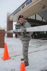 Senior Airman Richard Stafford, 319th Security Forces installation entry controller, closes the right lane for inbound traffic at the main gate of Grand Forks Air Force Base, N.D., Dec. 4, 2013. The lane was closed after inbound traffic diminished when the delayed reporting time of 9:30 a.m. was reached. (U.S. Air Force photo/Staff Sgt. Luis Loza Gutierrez) 
