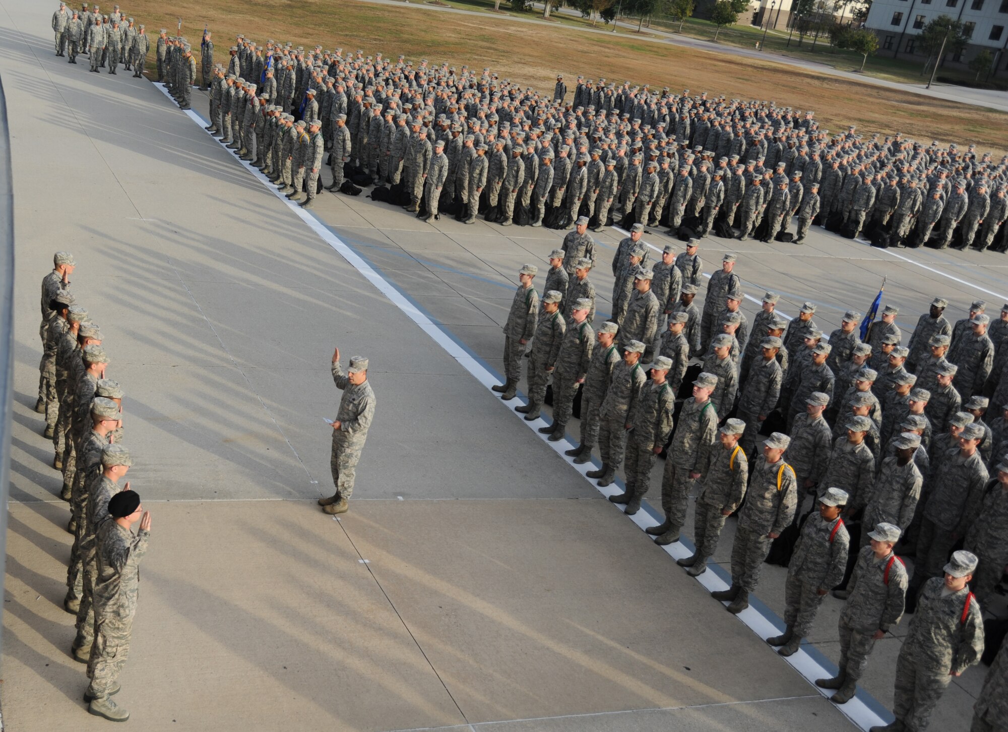 Col. George Tombe, 81st Training Group commander, administers the oath of enlistment to the nine Training Group’s newest Airmen promotees during a dragon recognition presentation Dec. 3, 2013, behind the Levitow Training Support Facility, Keesler Air Force Base, Miss.  The ceremony reinforced their commitment as they take on new responsibilities with their new promotion. The event also included the announcements of Airman of the Month, military training flight of the Month for November and two achievement medals.  (U.S. Air Force photo by Kemberly Groue)