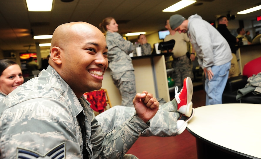 U.S. Air Force Senior Airman Kenneth Scott, 509th Operations Support Squadron aircrew flight equipment journeyman, celebrates as one of his teammates bowls a strike during a fundraiser for the Combined Federal Campaign at the Stars and Strikes Bowling Alley on Whiteman Air Force Base, Mo., Nov. 22, 2013. More than $900 was raised for the CFC during the fundraiser. Each year, the CFC allows Service members and civilians to make monetary contributions to their choice of more than 1,800 agencies, charities and organizations. CFC ends Dec. 15, 2013.  (U.S. Air Force photo by Staff Sgt. Nick Wilson/Released)