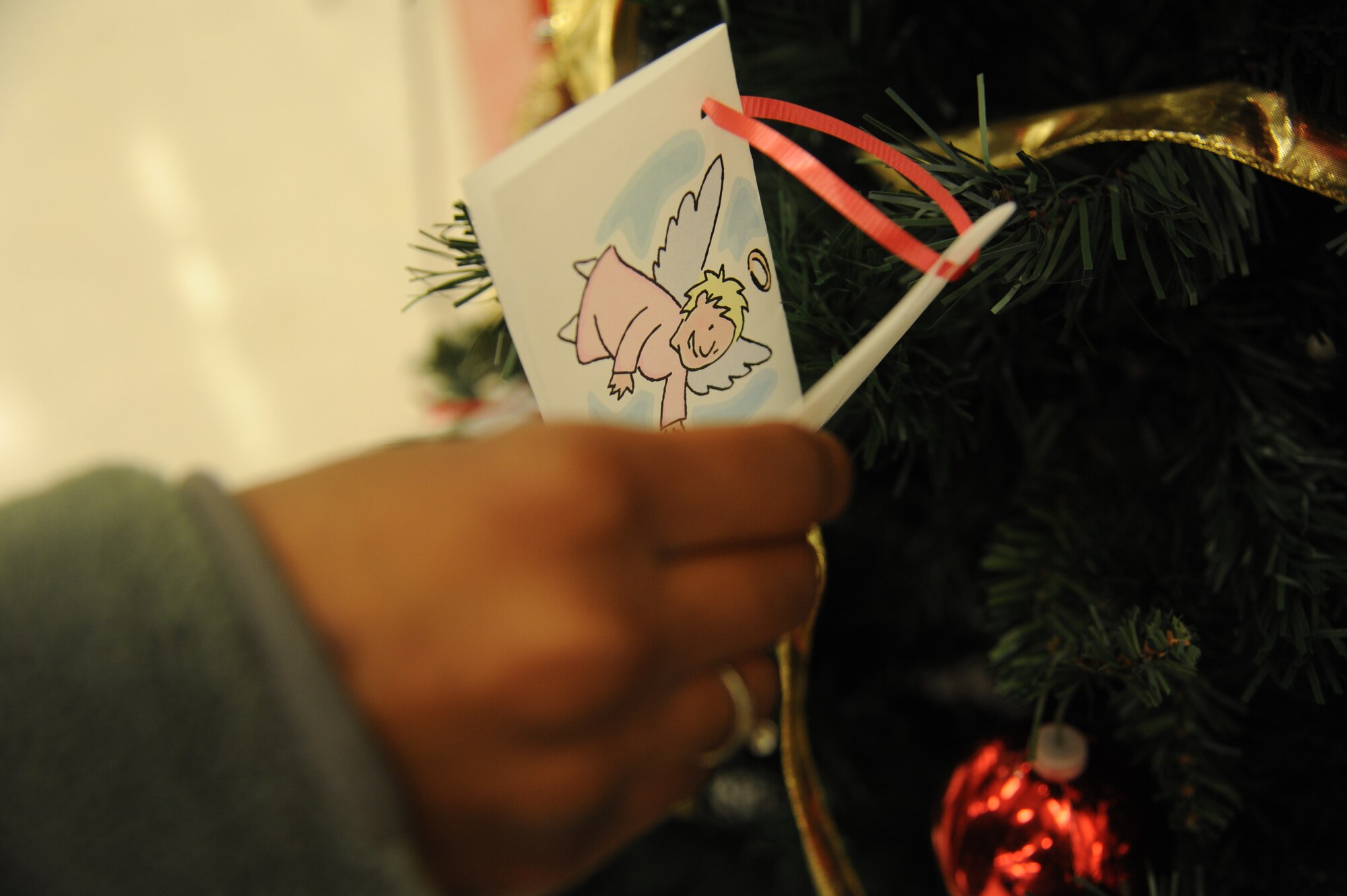 Two Angel Tree programs are being sponsored on base to support needy families during the holiday season.  Donations made to the Angel Tree at the Exchange benefit families stationed at Scott Air Force Base.  Chapel 1 and Chapel 2 have an Angel Tree, which supports families in East St. Louis.  (U.S. Air Force photo by Staff Sgt. Maria Bowman) 