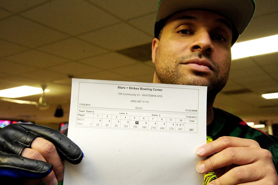 U.S. Air Force Tech. Sgt. Damian Bunch, 509th OSS aircrew flight equipment training manager, displays a printout of one of his games after bowling a 297 during a fundraiser for the Combined Federal Campaign at the Stars and Strikes Bowling Alley on Whiteman Air Force Base, Mo., Nov. 22, 2013. Bunch helped his team win one of two bowling events, which raised more than $900 for the CFC. Each year, the CFC allows Service members and civilians to make monetary contributions to their choice of more than 1,800 agencies, charities and organizations. CFC ends Dec. 15, 2013.  (U.S. Air Force photo by Staff Sgt. Nick Wilson/Released)