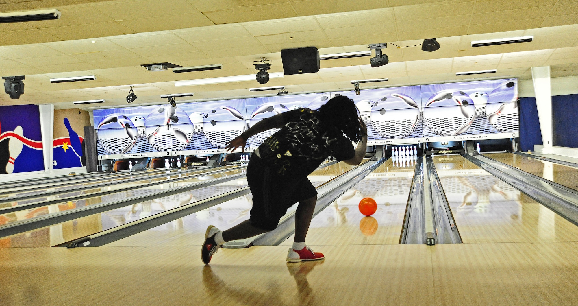 Willie Reid Jr., husband of U.S. Air Force Airman 1st Class Tamila Reid, 509th Operations Support Squadron combat crew technician, bowls during a fundraiser for the Combined Federal Campaign at the Stars and Strikes Bowling Alley on Whiteman Air Force Base, Mo., Nov. 22, 2013. More than $900 was raised during the fundraiser. Each year, the CFC allows Service members and civilians to make monetary contributions to their choice of more than 1,800 agencies, charities and organizations. CFC ends Dec. 15, 2013. (U.S. Air Force photo by Staff Sgt. Nick Wilson/Released)