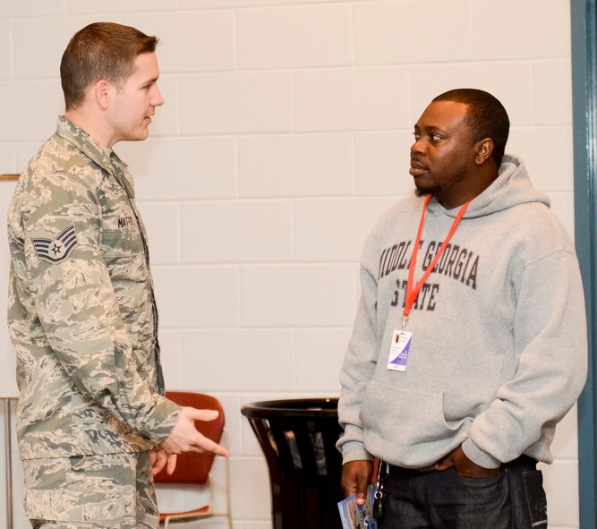 U.S. Air Force Staff Sgt. Jarred Mattox, a recruiter with the Georgia Air National Guard (GAANG), shares information with Christopher Jordan, an aircraft structural student at Middle Georgia State College, about opportunities available in the GAANG, Eastman, Ga., Dec. 4, 2013. Mattox along fellow recruiter Tech. Sgt. Jose Padilla and Lt. Col. John Verhage, 116th Operations Group deputy commander, attended the student assembly as part of the Georgia National Guard Podium Week meant to share the story and successes of the Georgia National Guard. (U.S. Air National Guard photo by Tech. Sgt. Regina Young/Released)