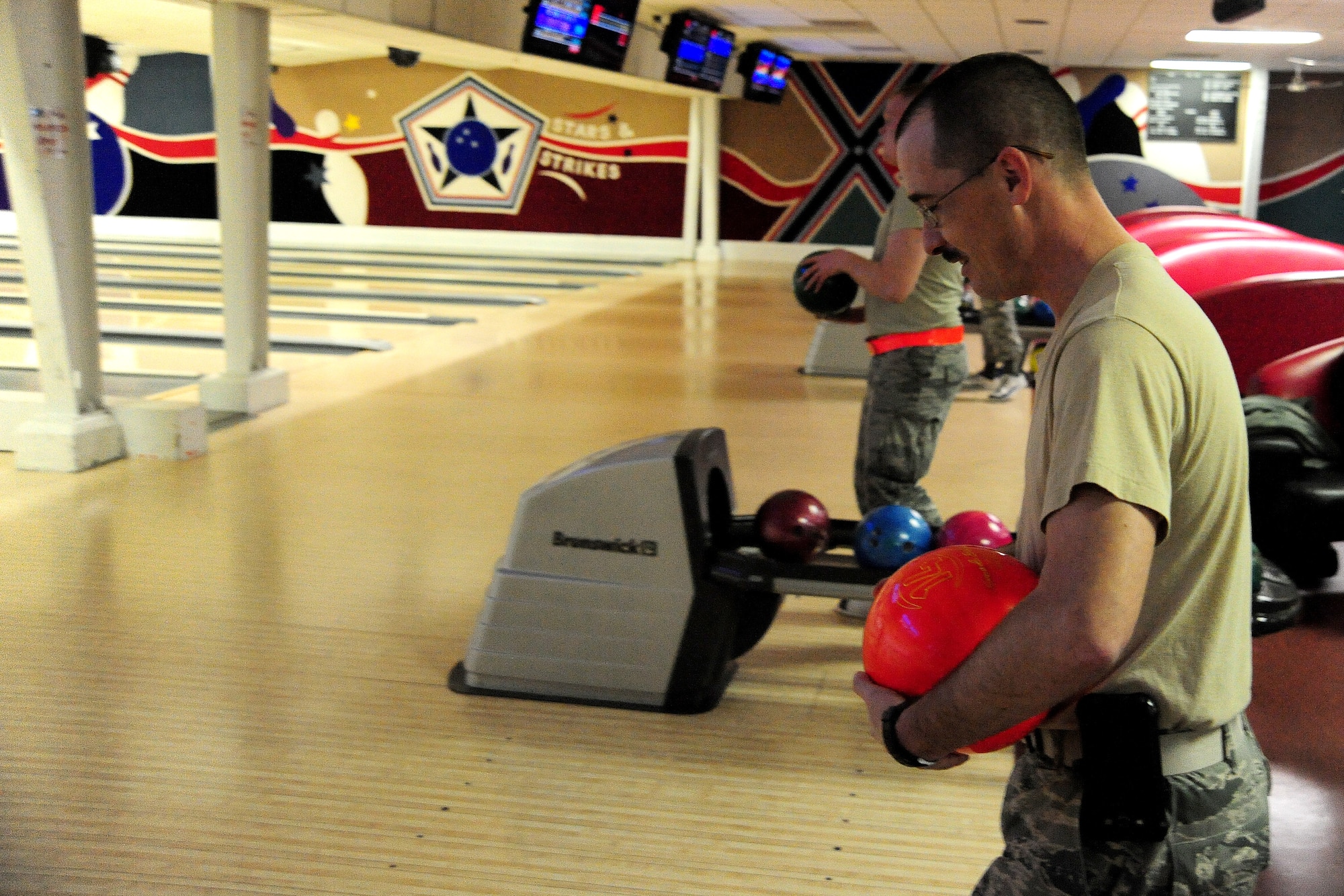U.S. Air Force Master Sgt. Joseph Dancy prepares to bowl during a fundraiser for the Combined Federal Campaign at the Bowling Alley on Whiteman Air Force Base, Mo., Nov. 22, 2013. More than $900 was raised during the fundraiser. Each year, the CFC allows Service members and civilians to make monetary contributions to their choice of more than 1,800 agencies, charities and organizations. CFC ends Dec. 15, 2013. (U.S. Air Force photo by Staff Sgt. Nick Wilson/Released)