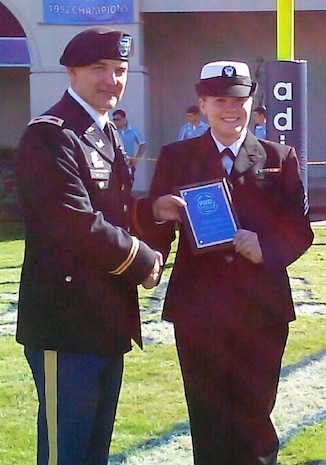 Seaman Paige Hensel, Navy Munitions Command Unit Charleston mineman, receives the 2013 Palmetto Chapter of Women in Defense “Military Woman of the Year” award from Retired Army Col. Ronald Welch, The Citadel dean of engineering, Nov. 16, 2013, at the Citadel football game in Charleston, S.C. The Women in Defense’s goal is provide networking and professional development opportunities to promote the role of women in national defense and security, to support military service members, and to encourage partnerships between the local contractor community and military personnel at Joint Base Charleston and the Department of Homeland Security. (Courtesy Photo)