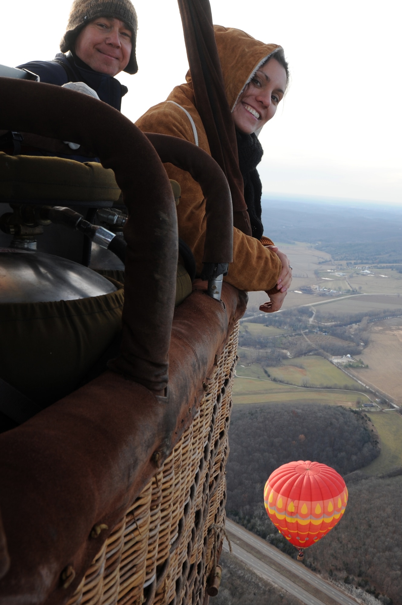 Airman 1st Class Nina Orlando, 375th Public Affairs broadcast journalist and Garry Green, Outdoor Recreation's Adventure Program director smile while up in a hot air balloon Nov. 24. Green said “It felt as if I was standing still and the earth was turning below me.” (U.S. Air Force photo/Airman Megan Friedl)