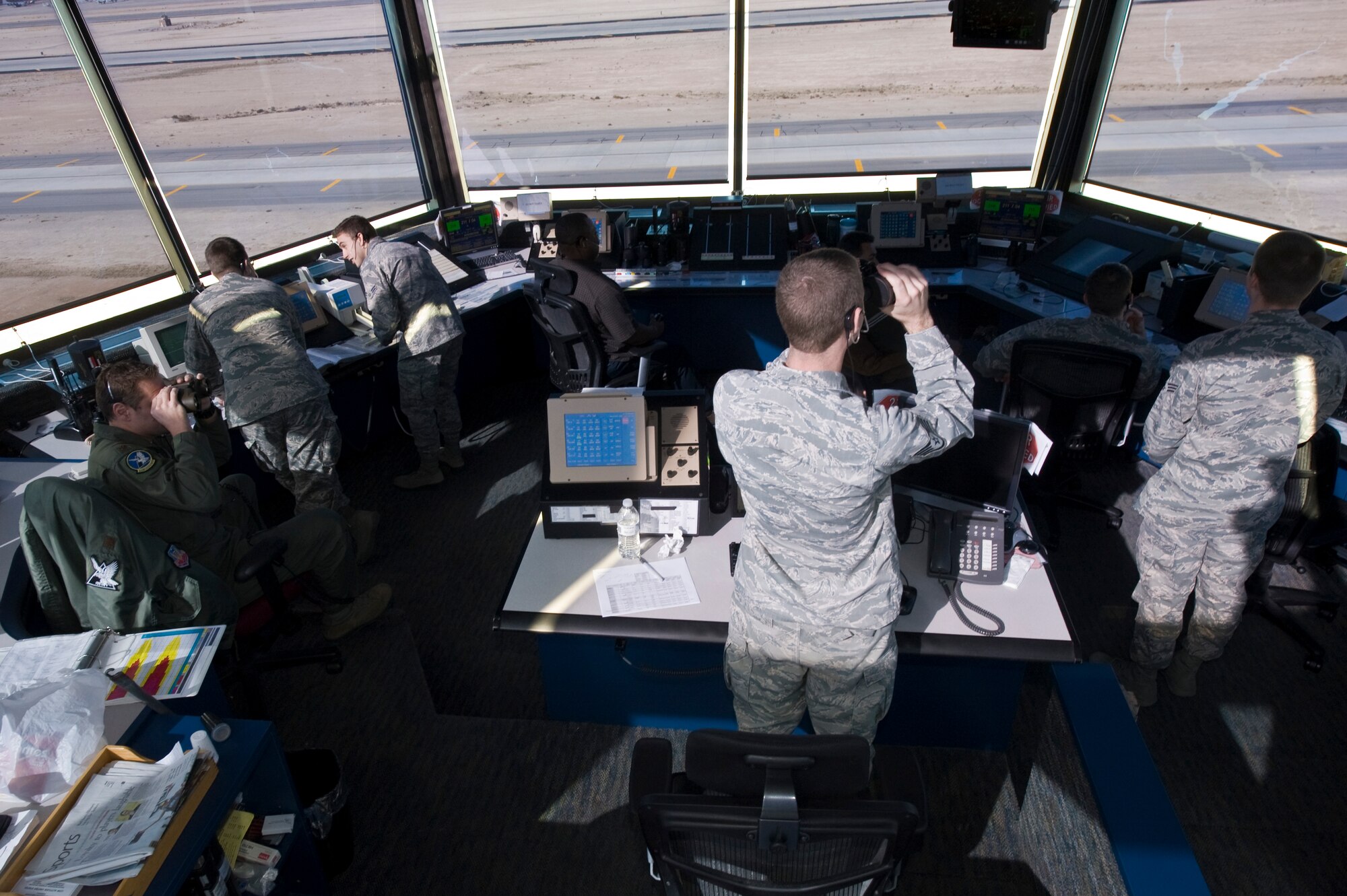 Air Traffic Controllers, 57th Operations Support Squadron, prepare for aircraft launches at the air traffic control tower Nov. 27, 2013, at Nellis Air Force Base, Nev. All ATC specialists must maintain a Federal Aviation Administration Specialist certification to remain qualified. ATC specialists at Nellis AFB manage the flow of air traffic on the ground and in 50,000 square miles of air space. (U.S. Air Force photo by Airman 1st Class Monet Villacorte)