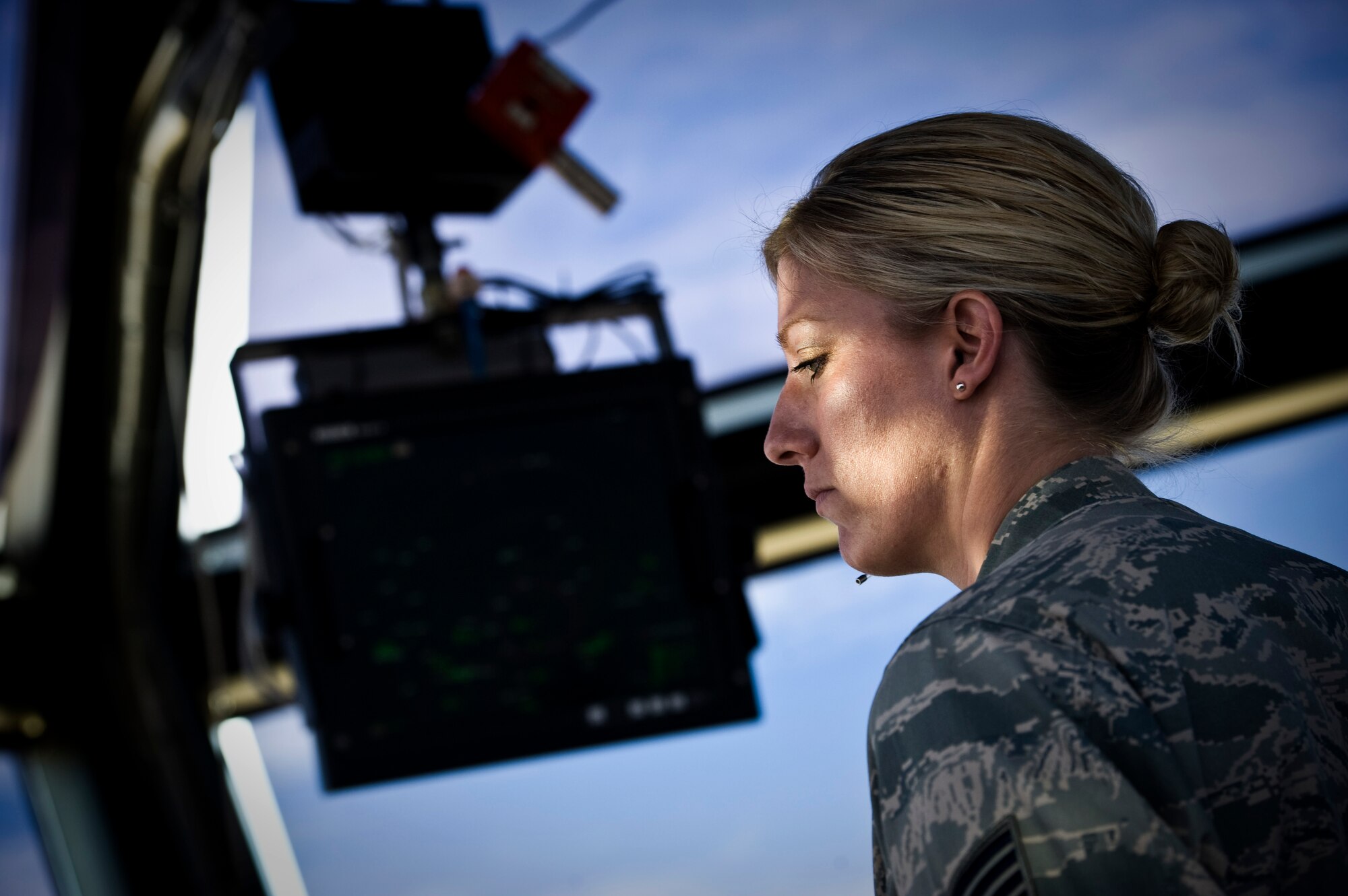 U.S. Air Force Tech. Sgt. Katherine Eliason, 57th Operations Support Squadron air traffic controller watch supervisor, uses a tower controller workstation in the air traffic control tower Nov. 27, 2013, at Nellis Air Force Base, Nev. Communication is vital for air traffic controllers because they must focus on the exact words that pilots and other controllers speak in order to maintain a safe environment. (U.S. Air Force photo by Airman 1st Class Christopher Tam)