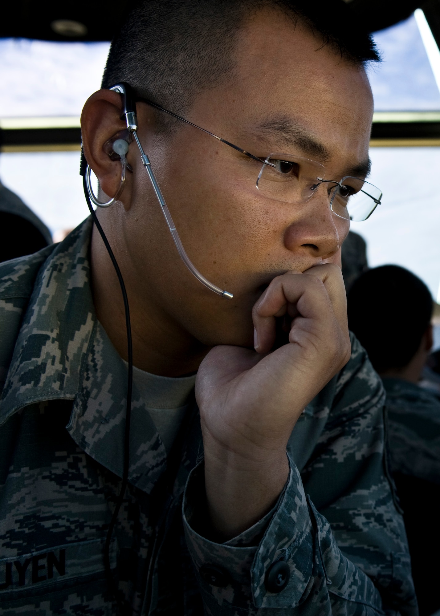 U.S. Air Force Tech. Sgt. Lan Nguyen, 57th Operations Support Squadron air traffic controller, uses an enhanced terminal voice switch to communicate to other local air control towers in the air traffic control tower Nov. 27, 2013, at Nellis Air Force Base, Nev. Air traffic controllers are people trained to maintain the safe, orderly and expeditious flow of air traffic in the global air traffic control system. (U.S. Air Force photo by Airman 1st Class Christopher Tam)