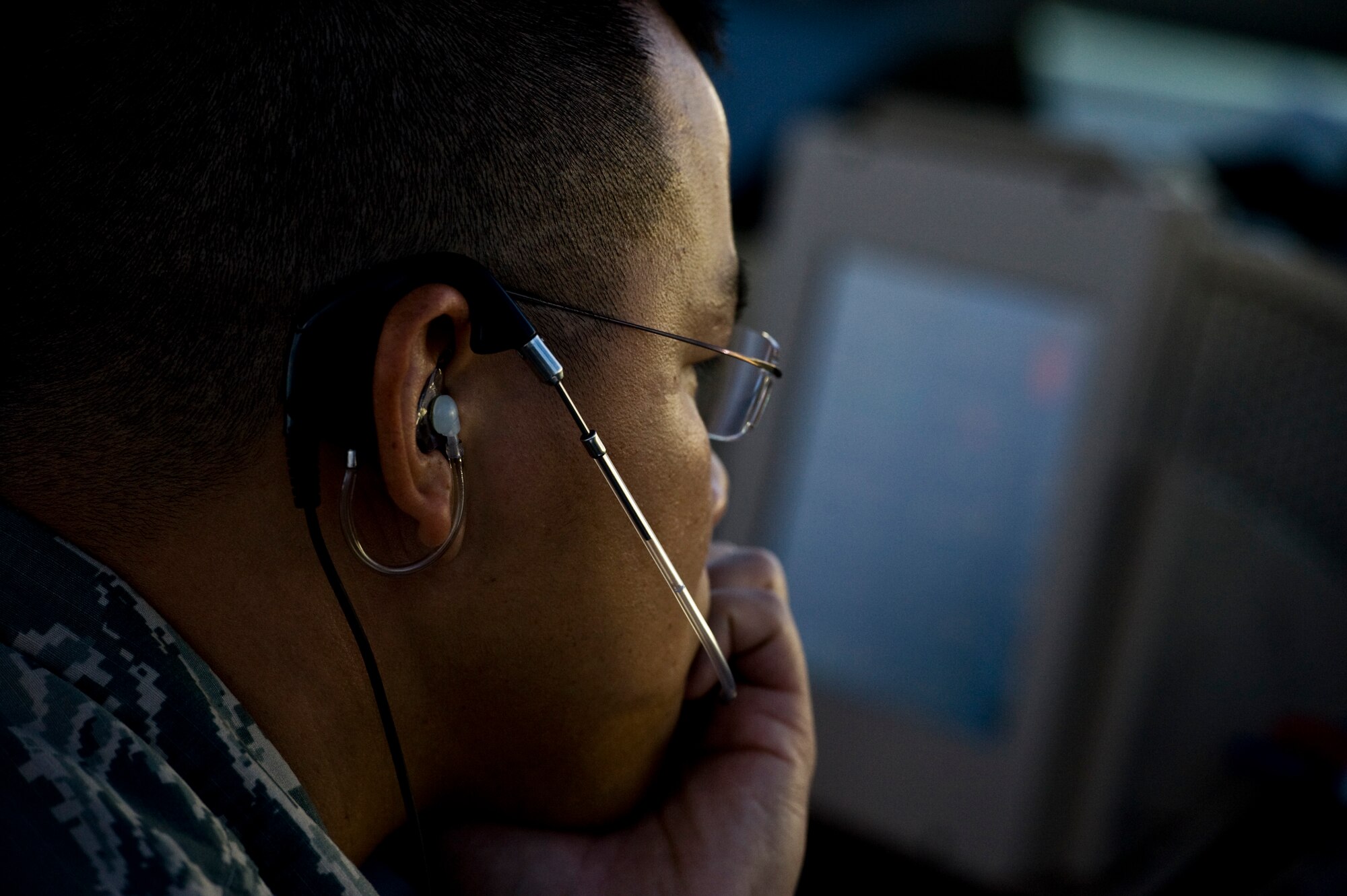 U.S. Air Force Tech. Sgt. Lan Nguyen, 57th Operations Support Squadron air traffic controller, uses an enhanced terminal voice switch to communicate to other local air control towers in the air traffic control tower Nov. 27, 2013, at Nellis Air Force Base, Nev. Enhanced terminal voice switches provide air traffic controllers access to telephone lines, air-ground radios and intercommunications. (U.S. Air Force photo by Airman 1st Class Christopher Tam)