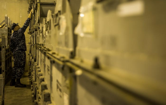 Petty Officer 1st Class Frank Alvarado, NMC Unit Charleston quality assurance inspectors, checks the serial numbers on ordnance inside of a magazine Nov. 21, 2013, at Joint Base Charleston – Weapons Station, S.C. The quality assurance inspectors make sure the ordnance inside the magazines are maintained year round and were given a satisfactory during the Explosive Safety Inspection on Nov. 21. (U.S. Air Force photo/ Senior Airman Dennis Sloan)