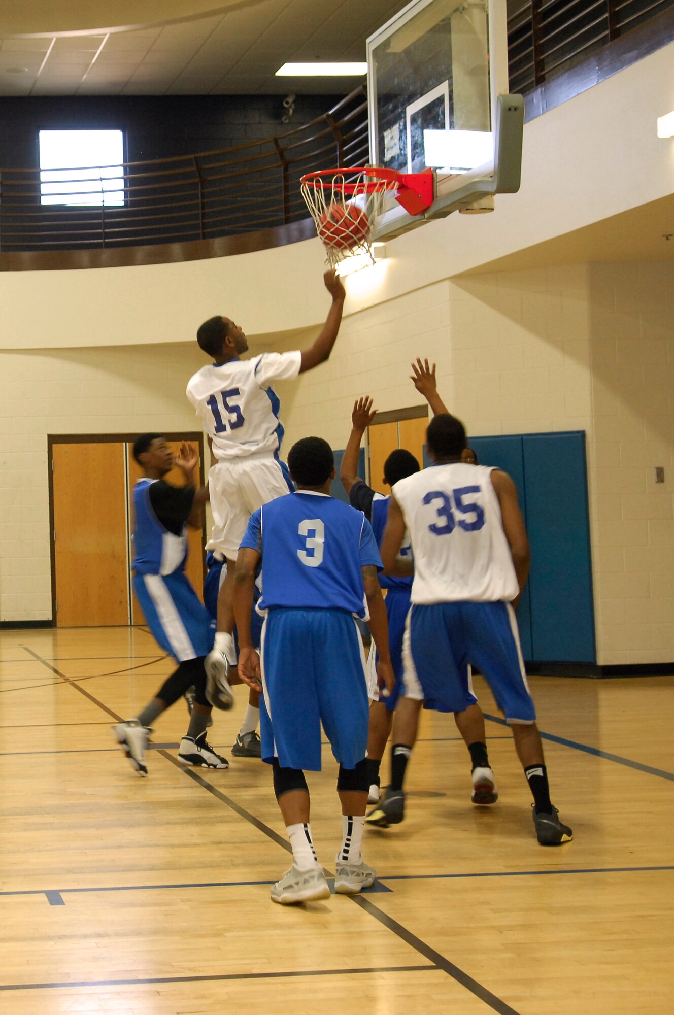 U.S. Air Force members of the Davis-Monthan Air Force Base, Ariz. basketball team play in a basketball game against a team from Luke Air Force Base, Ariz., at D-M Nov. 29, 2013. The Best of the West Basketball Tournament is an annual competition that allows civilian teams and military teams to compete against each other. (U.S. Air Force photo by Airman 1st Class Betty R. Chevalier/released)