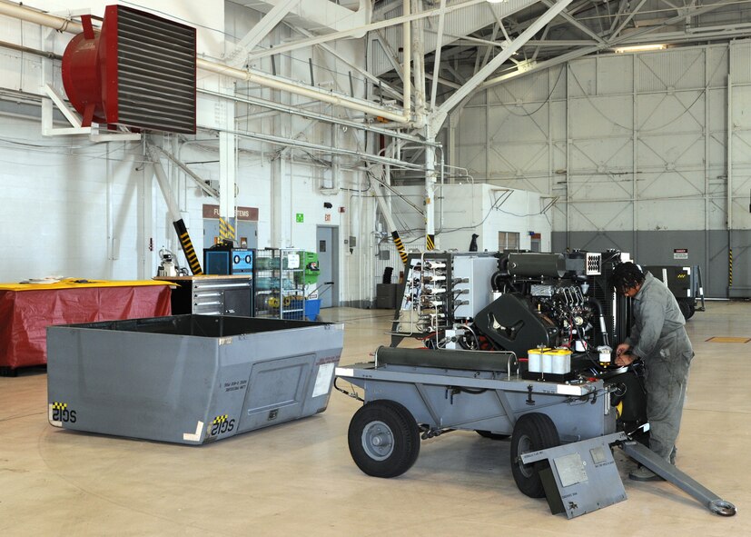Airman 1st Class Toni Petty, 307th Aerospace Ground Equipment journeyman, mounts a gas line on a self-generating nitrogen cart on Barksdale Air Force Base, La., Dec. 3, 2013. Petty removed the gas line to perform maintenance on the fuel tank and determine why the fuel gauge wasn't reading properly. (U.S. Air Force photo/Senior Airman Joseph A. Pagán Jr.)