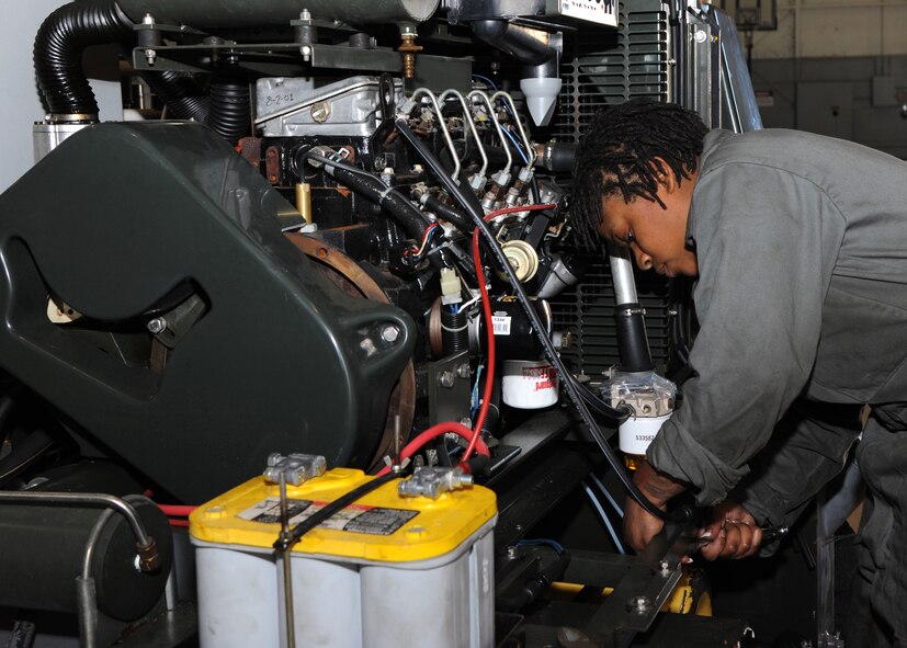 Airman 1st Class Toni Petty, 307th Aerospace Ground Equipment journeyman, mounts a gas line on a self-generating nitrogen cart on Barksdale Air Force Base, La., Dec. 3, 2013. A SGNC is used to turn air into nitrogen so it can be used to fill the tires on a B-52H Stratofortress. Air pressure in a tire changes with the weather, and nitrogen helps sustain the correct pounds per square inch. (U.S. Air Force photo/Senior Airman Joseph A. Pagán Jr.)