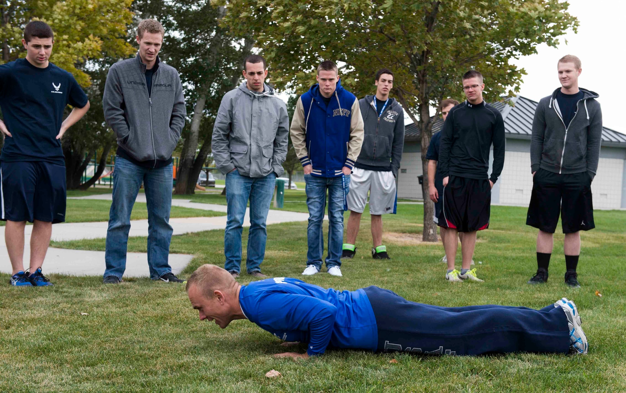 Tech. Sgt. Michael Lundell, 368th Recruiting Squadron recruiter, teaches his delayed entry program candidates how to properly do a push up in preparation for Basic Military Training in West Valley, Utah, Oct. 3, 2013. Lundell grew up in Utah Co. and joined the Air Force in August 2003 as an aircrew life support airman. He was selected for recruiting and lives back in Utah for a four year assignment. (U.S. Air Force photo by Senior Airman Tiffany DeNault)


