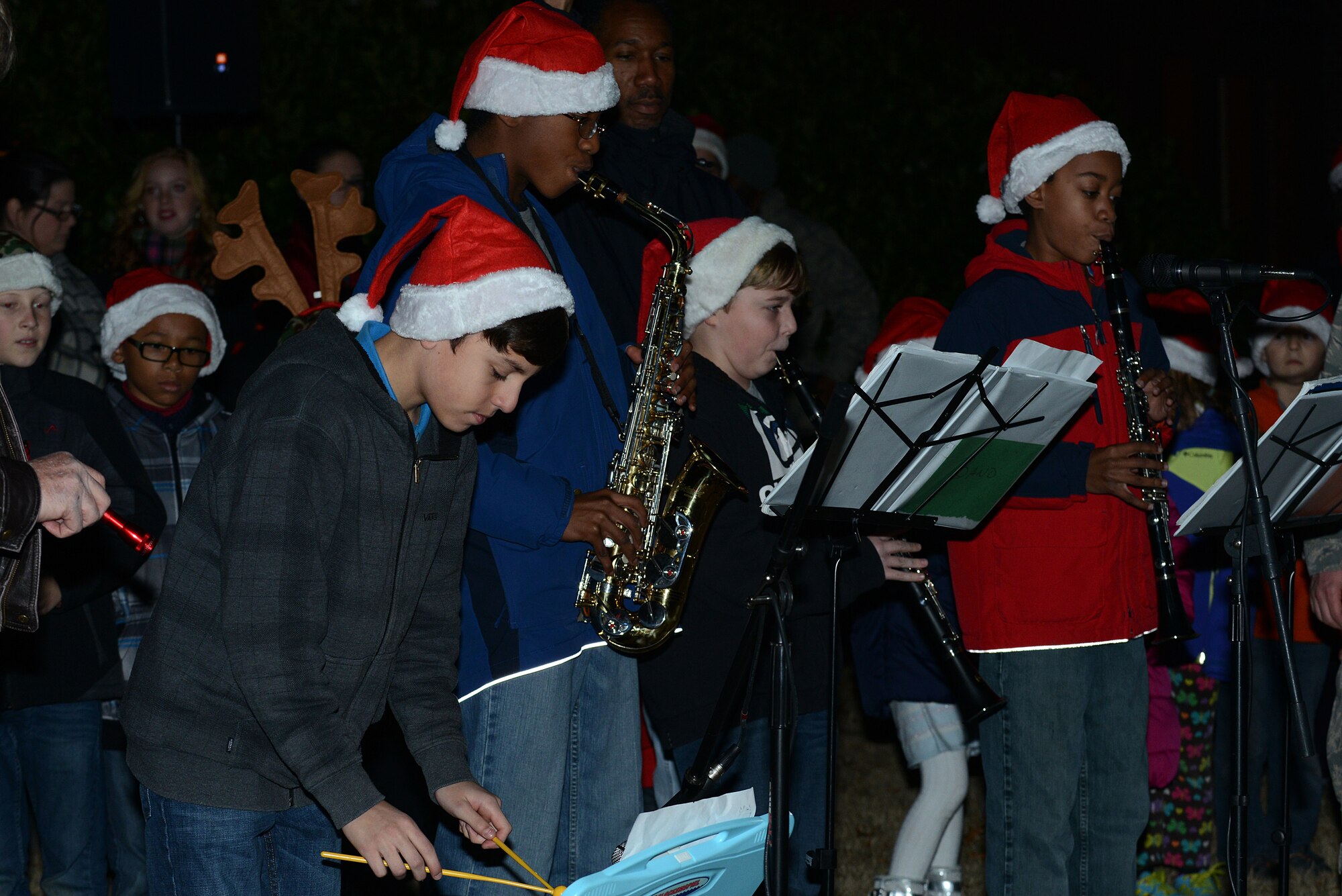 Children of the Bethel Manor Chapel Protestant Youth Choir perform at the tree-lighting ceremony on the chapel lawn at Langley Air Force Base, Va., Dec. 3, 2013. The ceremony also featured music and a visit from Santa Claus. (U.S. Air Force photo by Airman 1st Class Kimberly Nagle/Released)