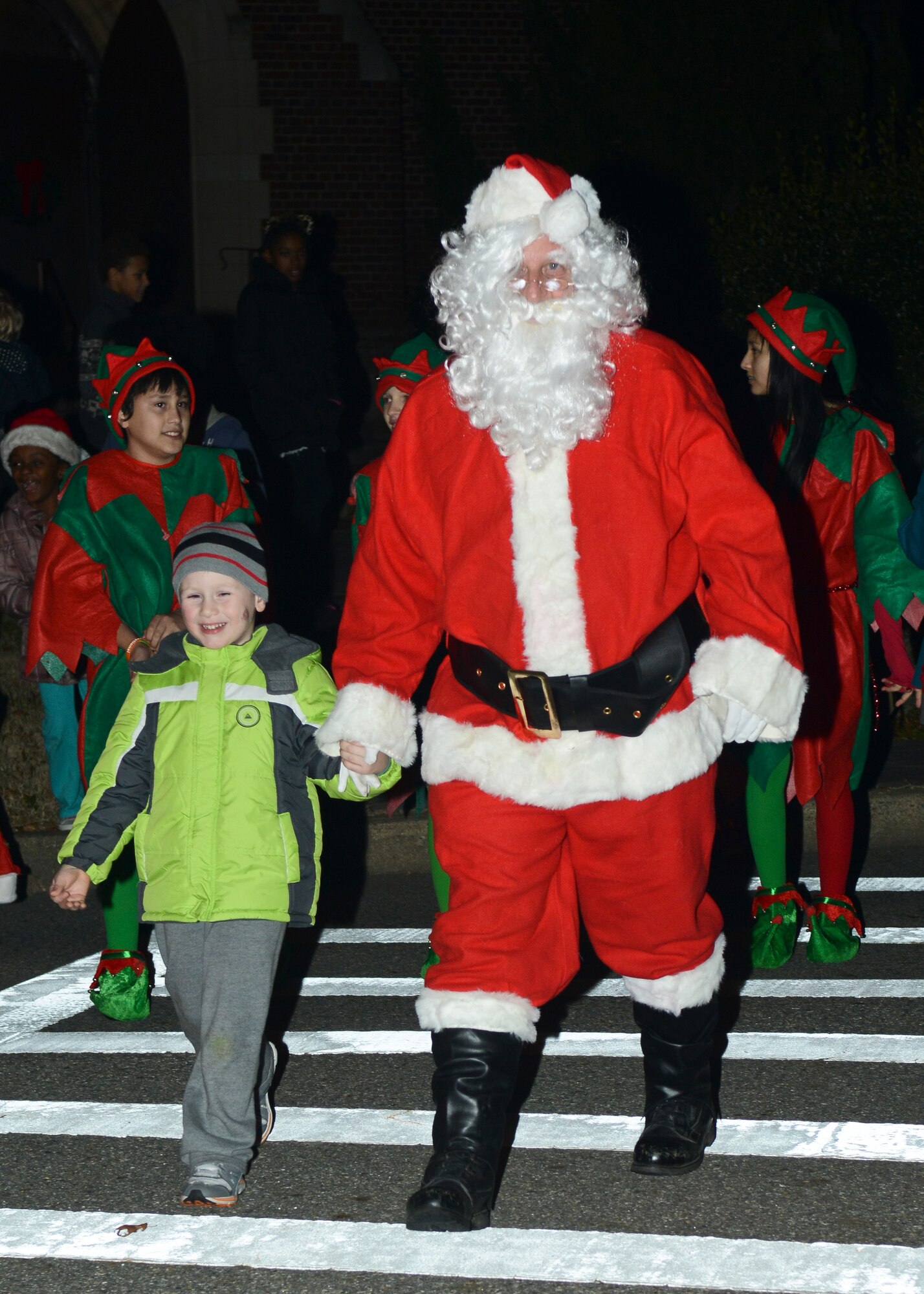 Santa Claus visits children during the Christmas tree lighting ceremony at Langley Air Force Base, Va., Dec. 3, 2013. Families who gathered for the annual ceremony enjoyed poem readings, holiday carols and a visit from Santa Claus. (U.S. Air Force photo by Airman 1st Class Victoria H. Taylor/ Released)