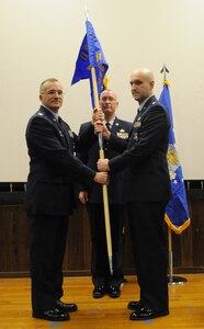 Capt. Charles Tenney (right), 11th Security Support Squadron commander, takes the guideon from Col. Erik Goepner, 11th Security Forces Squadron commander, at the activation ceremony of the 11th SSPTS, at Joint Base Andrews, Md., Dec. 3, 2013. The support squadron will provide an administrative role for the 11th Security Forces Group. (U.S. Air Force photo/Airman 1st Class Joshua R. M. Dewberry)