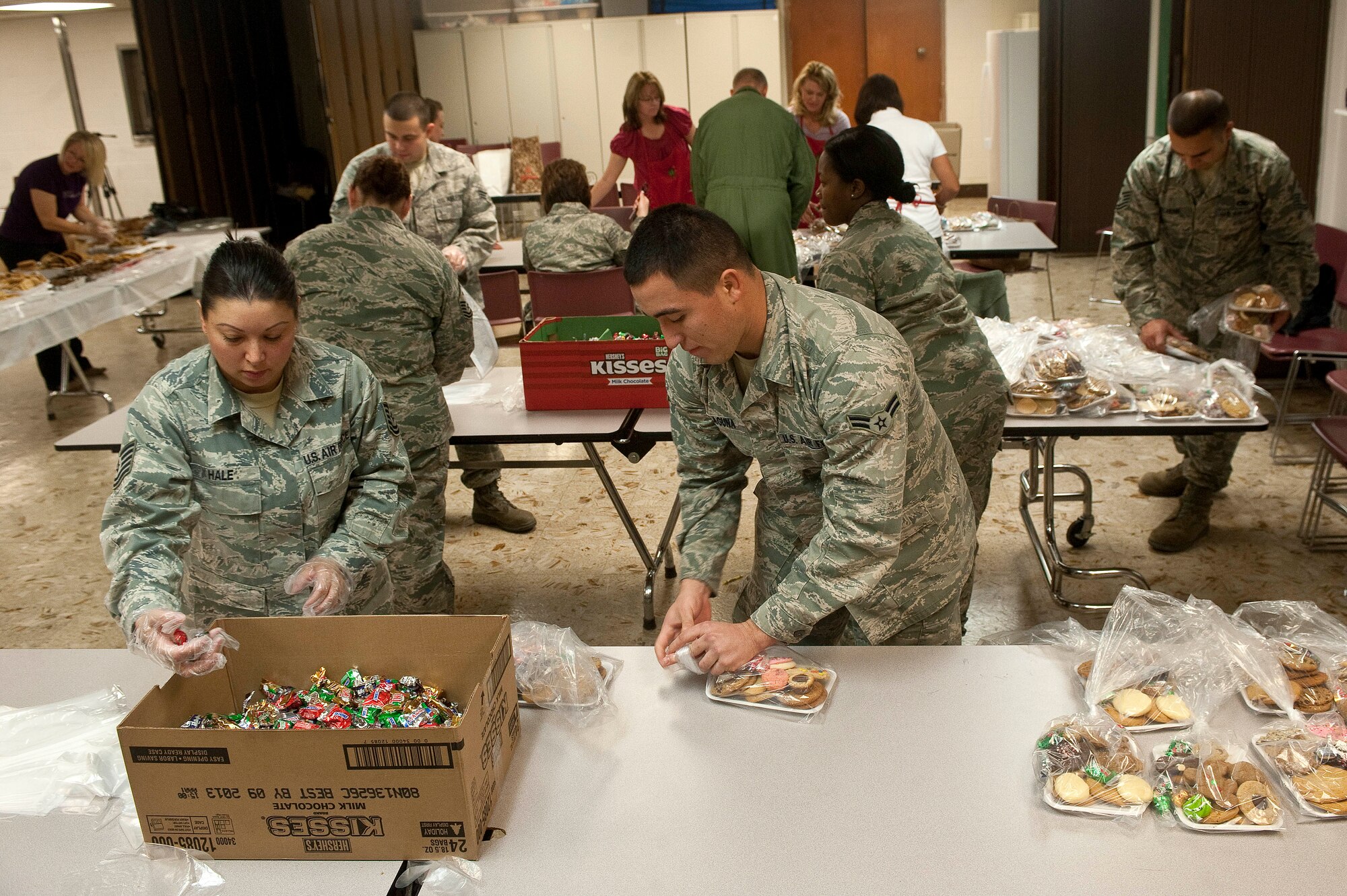 Tech. Sgt. Joanna Hale, 57th Adversary Tactics Support Squadron aircrew
flight equipment craftsman, and Airman 1st Class Christopher Laguna, 99th
Medical Support Squadron health services management journeyman, organize
cookies and candy during the Cookie Drive Dec. 11, 2012, at Nellis Air Force
Base, Nev. Cookies were collected, assorted and placed in bags for
distribution during the event. (U.S. Air Force photo by Staff Sgt.
Christopher Hubenthal)
