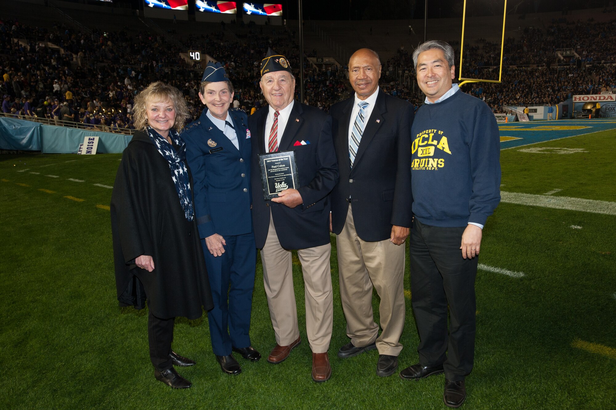 Paul Cohen (middle), 2013 Los Angeles County’s Department of Military and Veterans Affairs Veteran of the Year, receives the award Nov. 15 during a ceremony at the UCLA-Washington football game halftime show. Presenting the award were (from left to right): Brig. Gen. (ret.) Ruth A. Wong, Los Angeles County’s Department of Military and Veterans Affairs director; Lt. Gen. Ellen Pawlikowski, Space and Missile Systems Center commander; Army Maj. Gen. (ret.) Peter J. Gravett, California Department of Veteran Affairs secretary; and Al Muratsuchi, 66th District Assemblymember. (Courtesy photo)